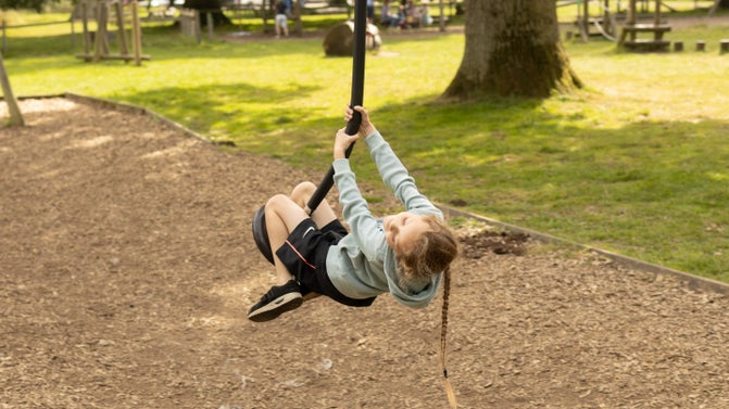Girl on zip wire at Ickworth play area
