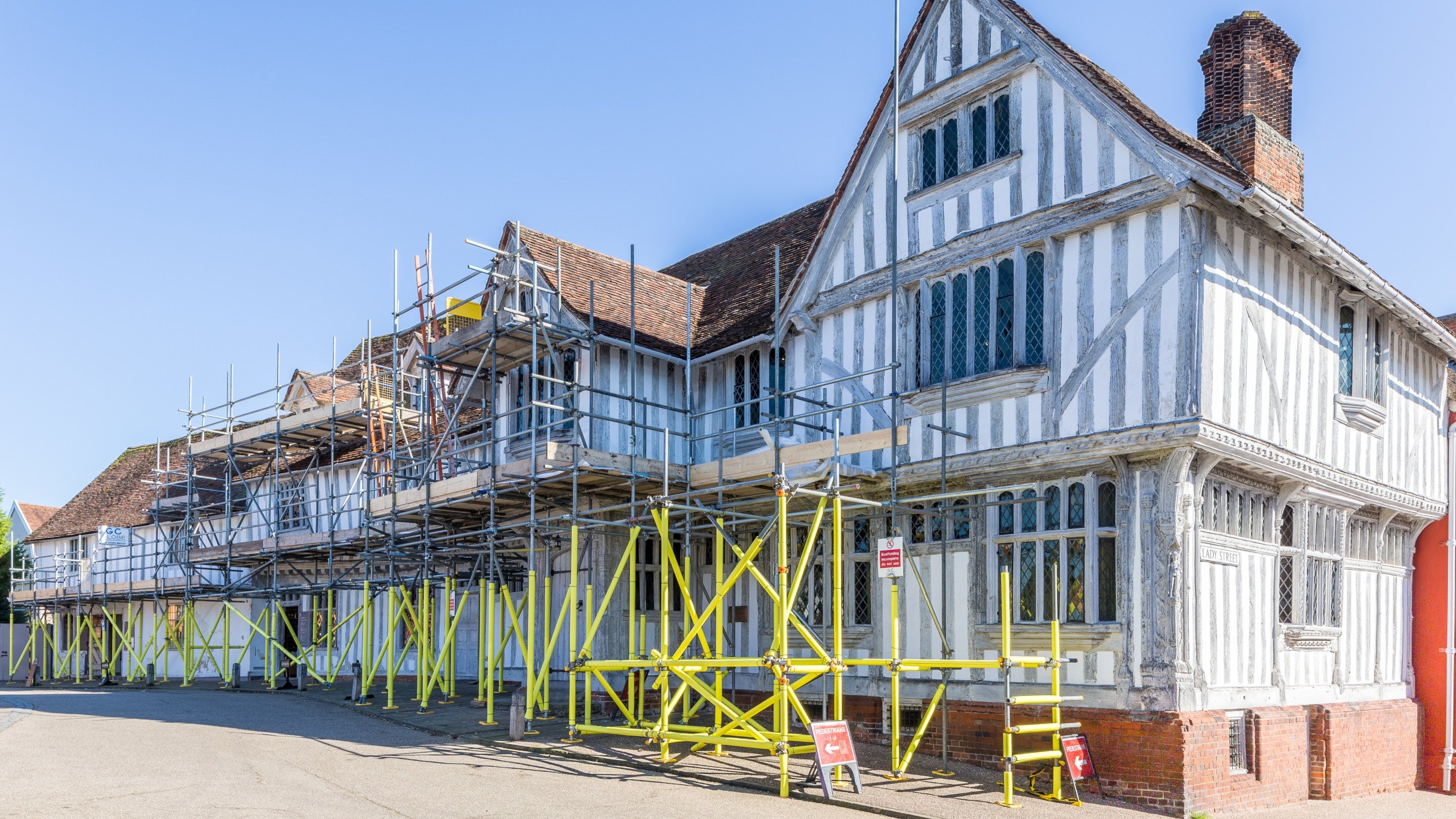 Scaffolding on the Market Place facade of Lavenham Guildhall, Suffolk, in preparation for limewashing.