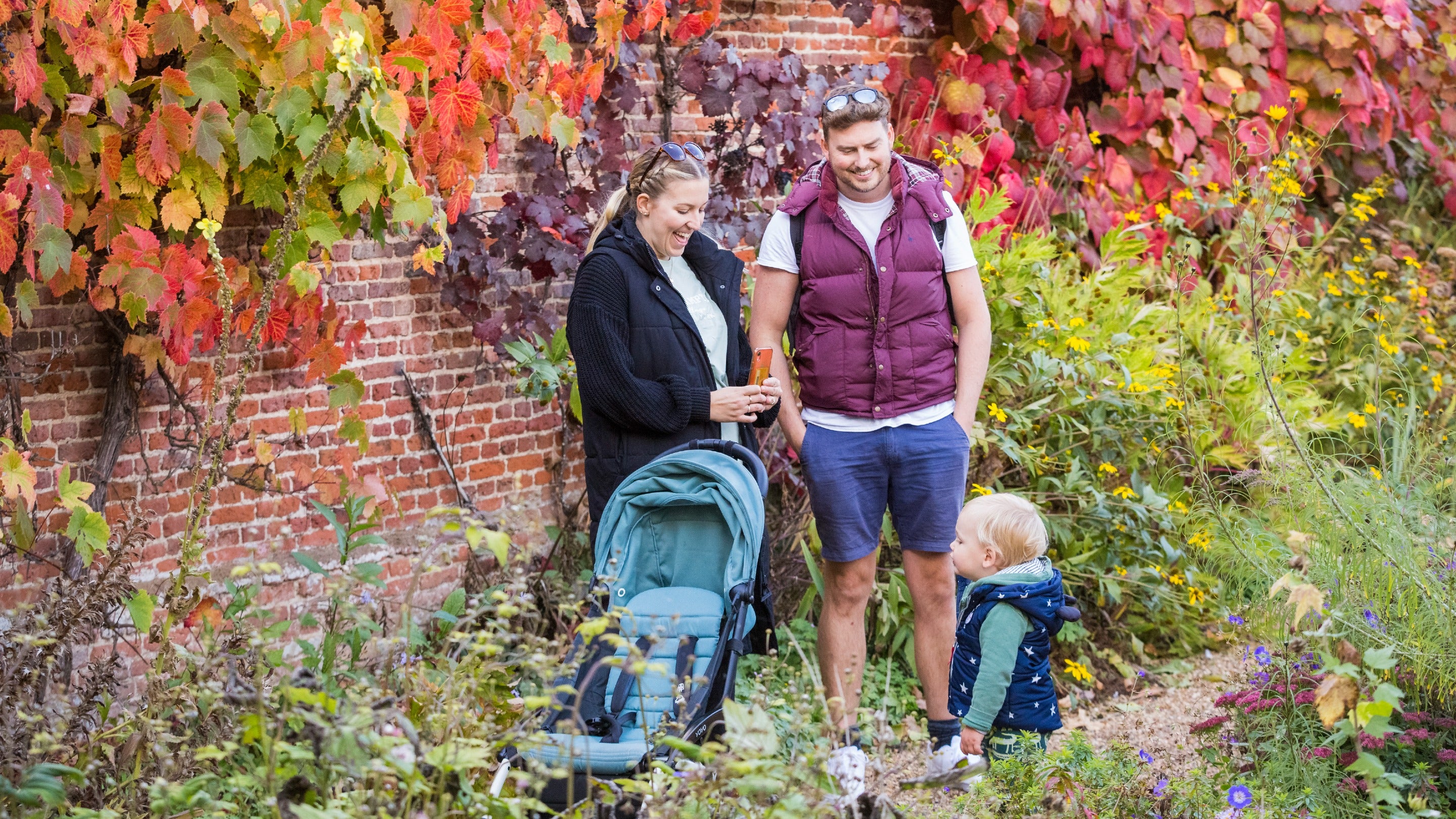 A young family in the garden at Melford Hall