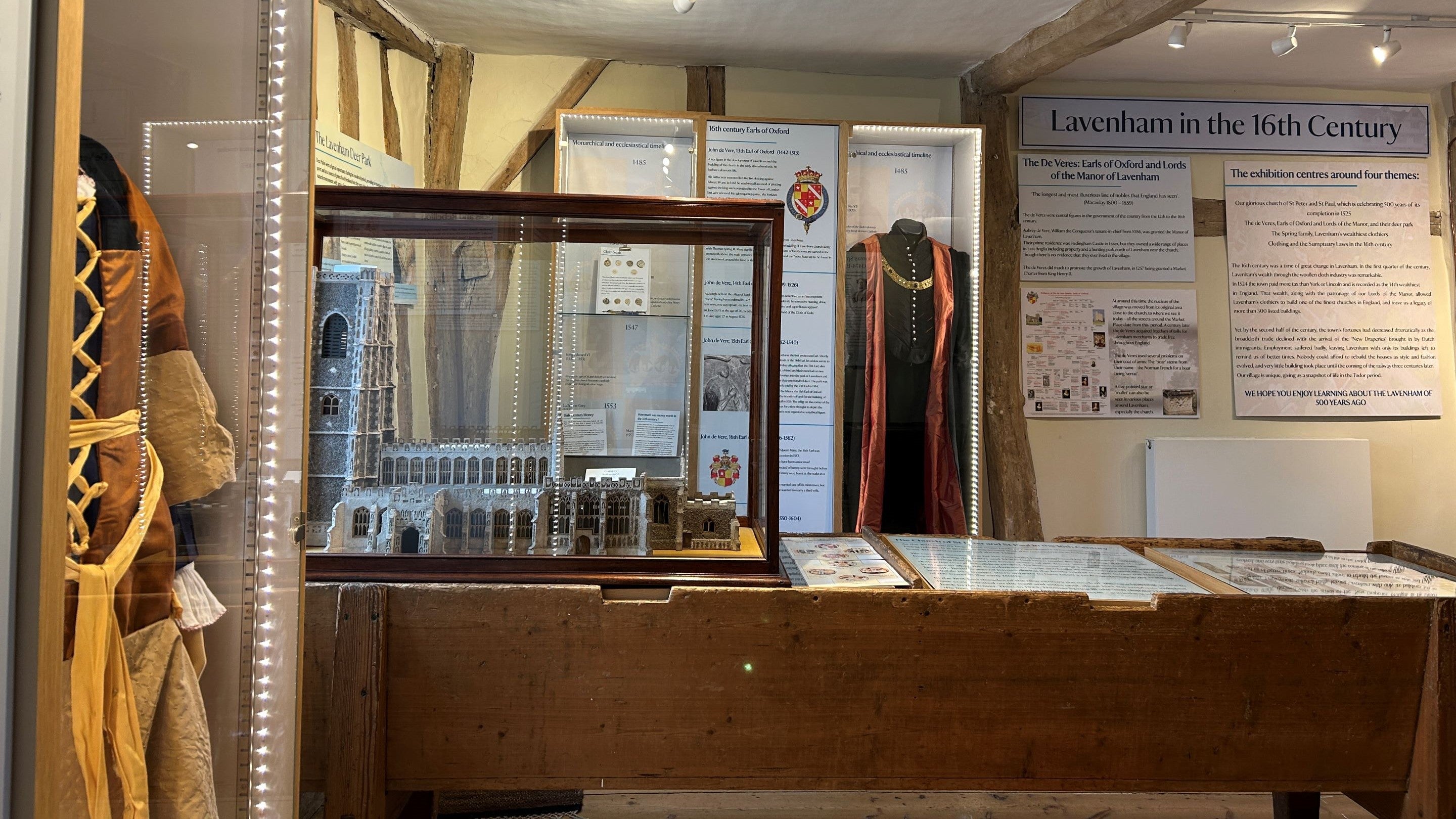 view of a room set up for an exhibition with show cases and displays