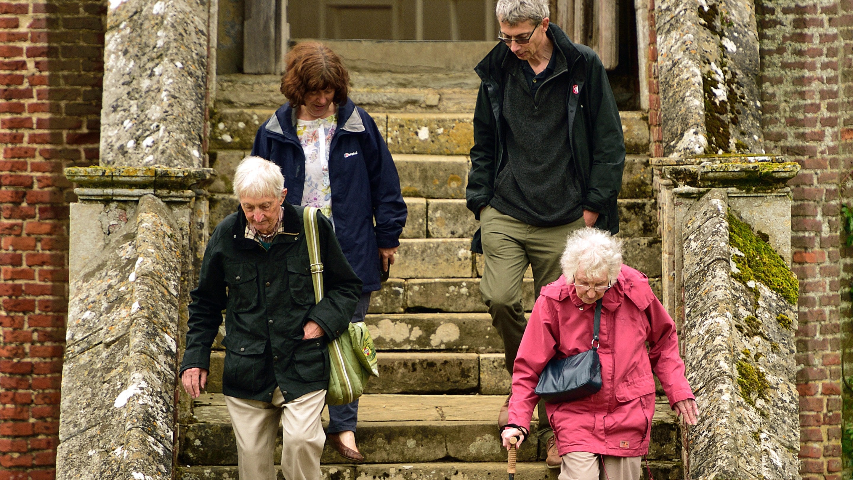 A group of visitors listening to a talk in the Great Hall at Melford Hall, Suffolk