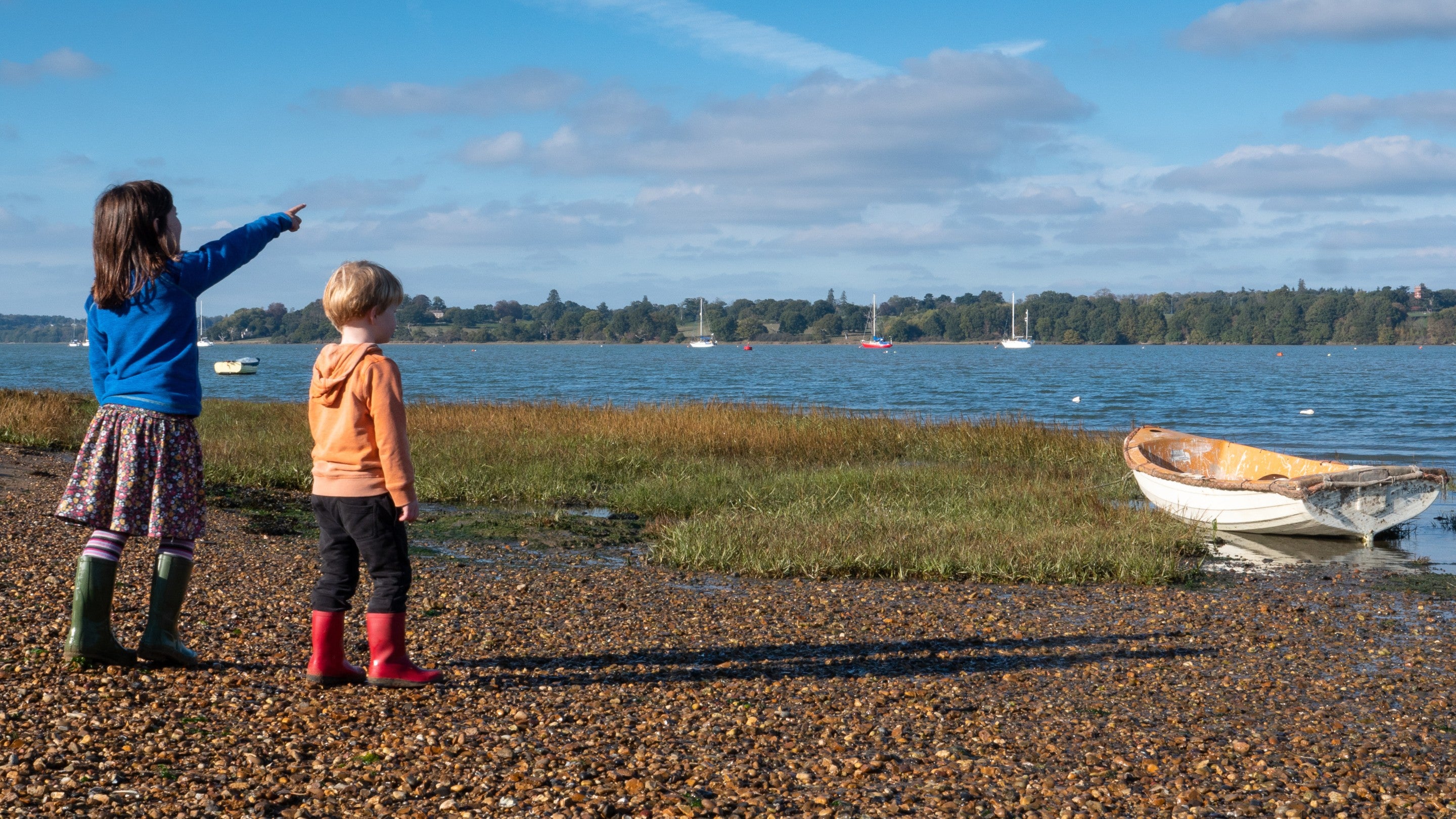 Children looking out across estuary at Pin Mill, Suffolk