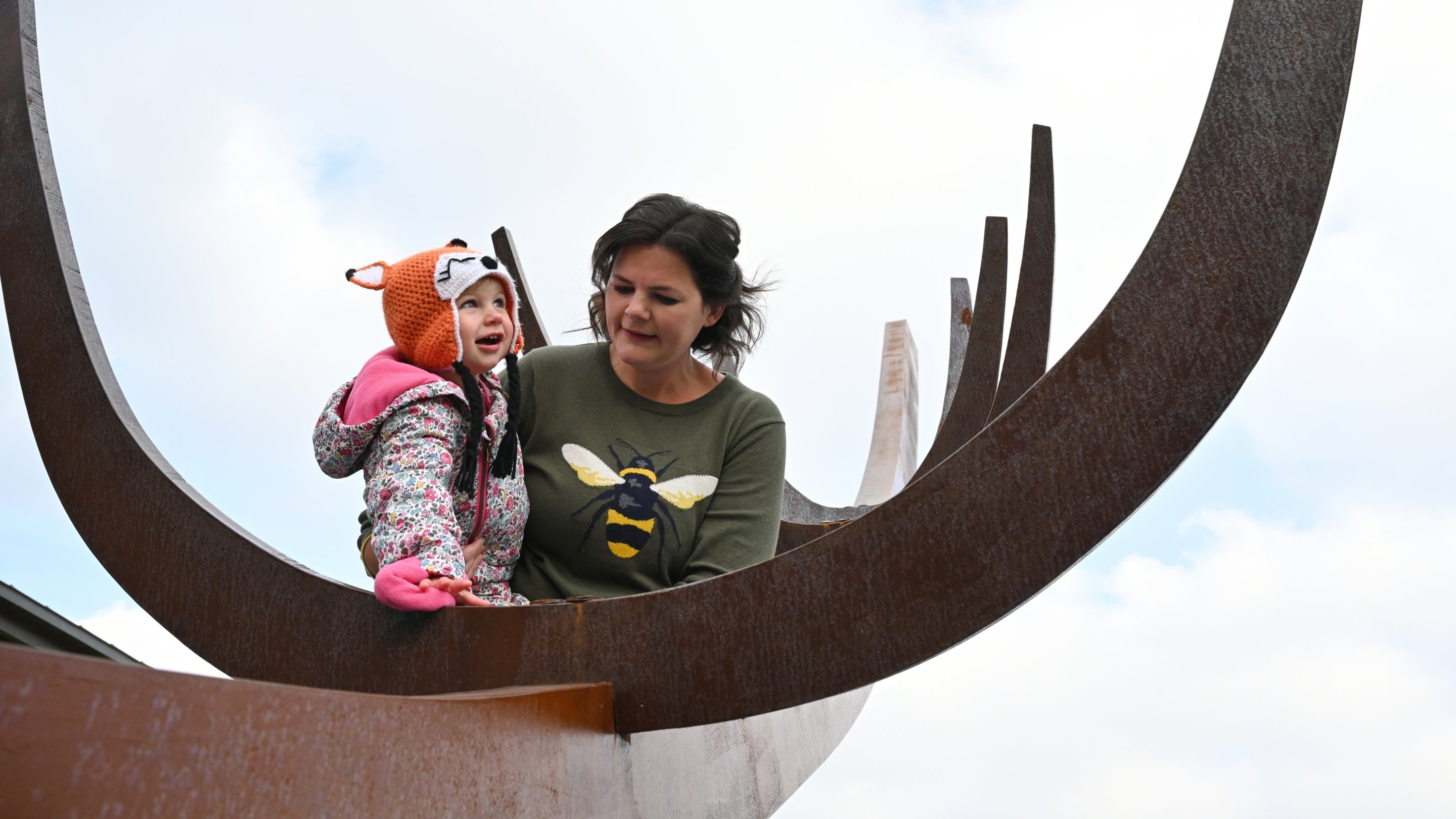 Mother and daughter by the contemporary full-size sculpture of an Anglo-Saxon ship at Sutton Hoo, Suffolk