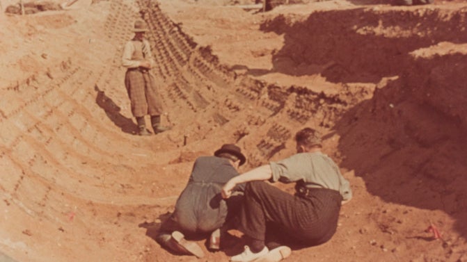 View of the prow of the ship and part of the burial chamber featuring Basil Brown and Charles Phillips.
