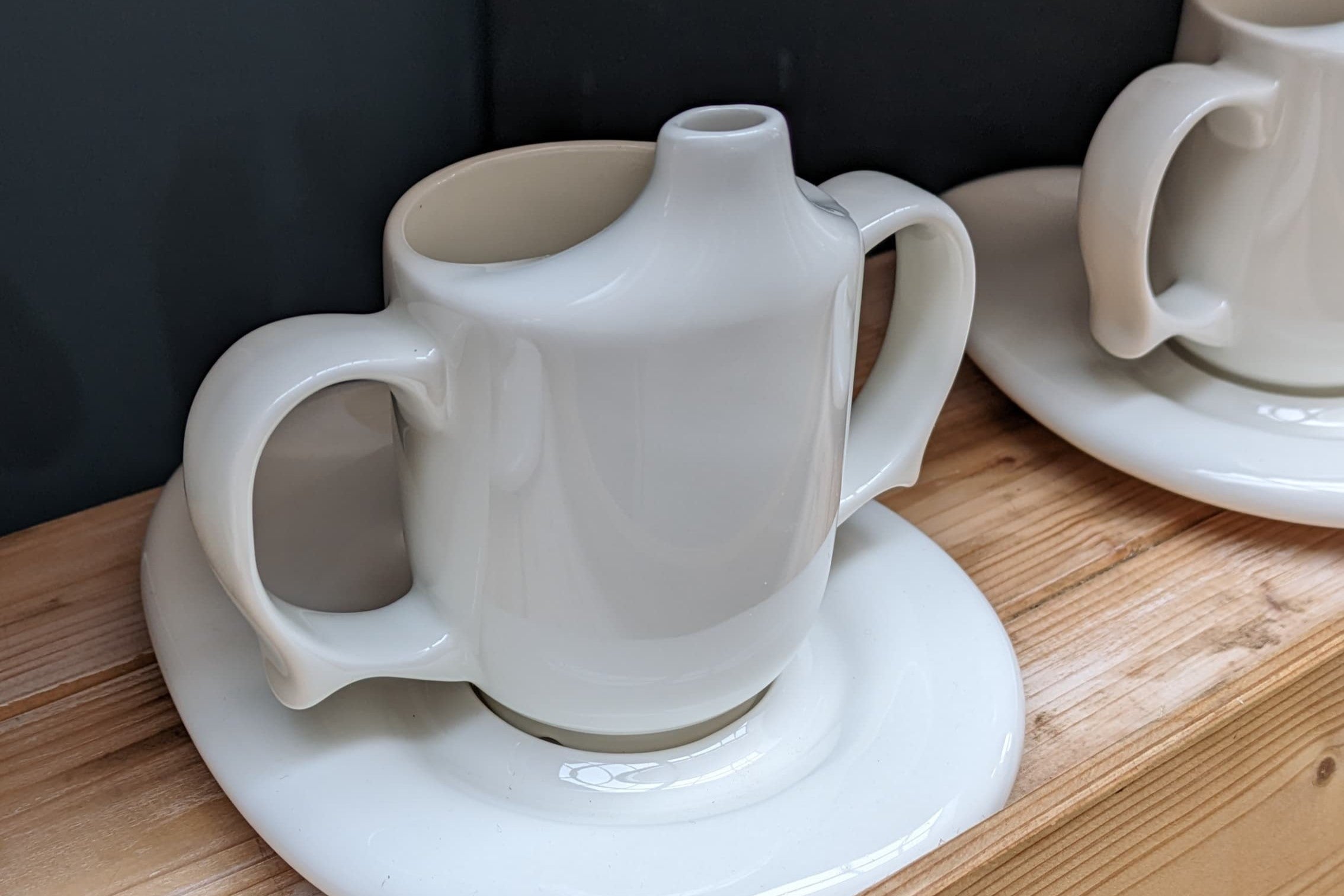 A row of ceramic two-handled cups