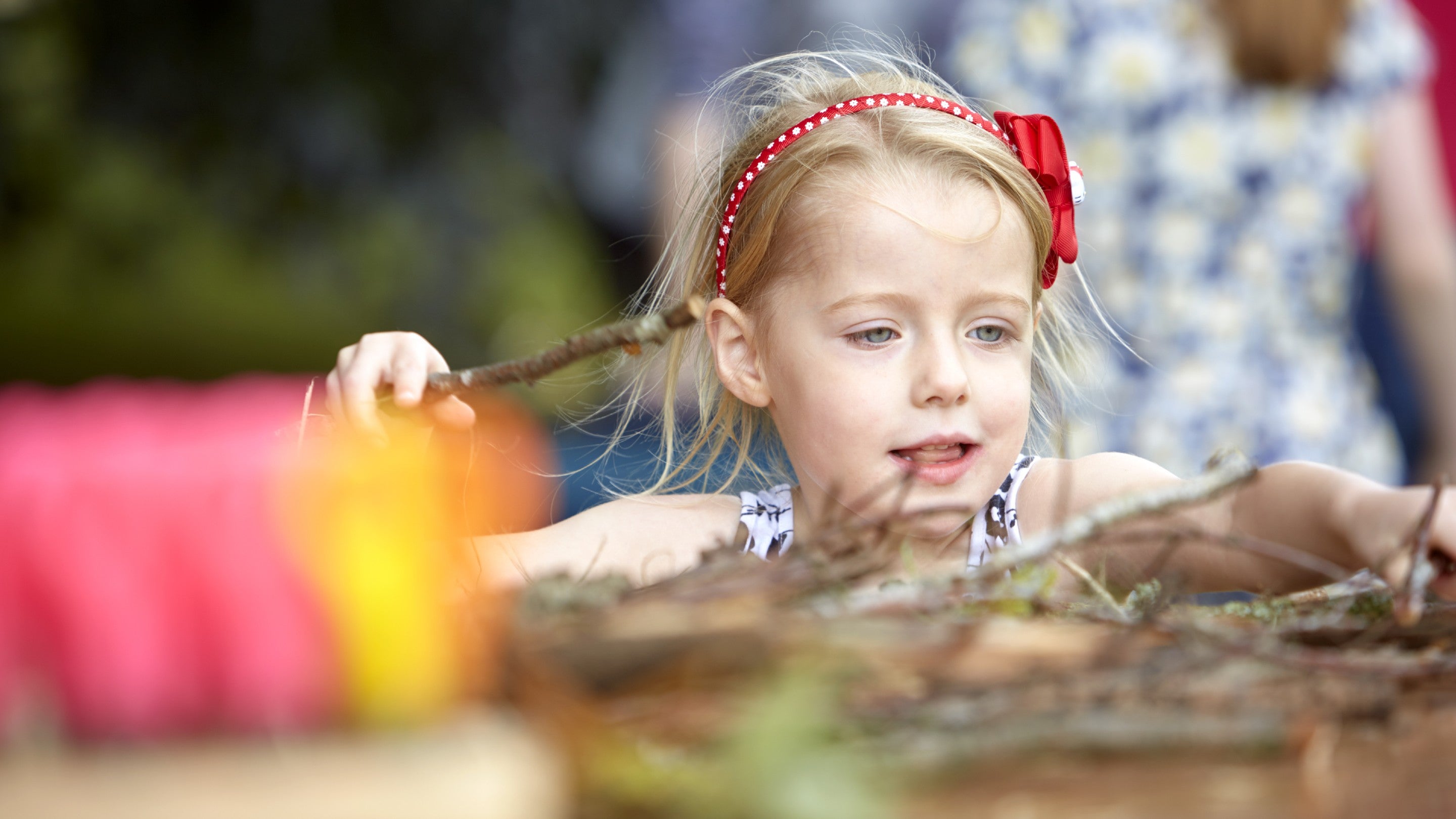Child using sticks and leaves to make wild art