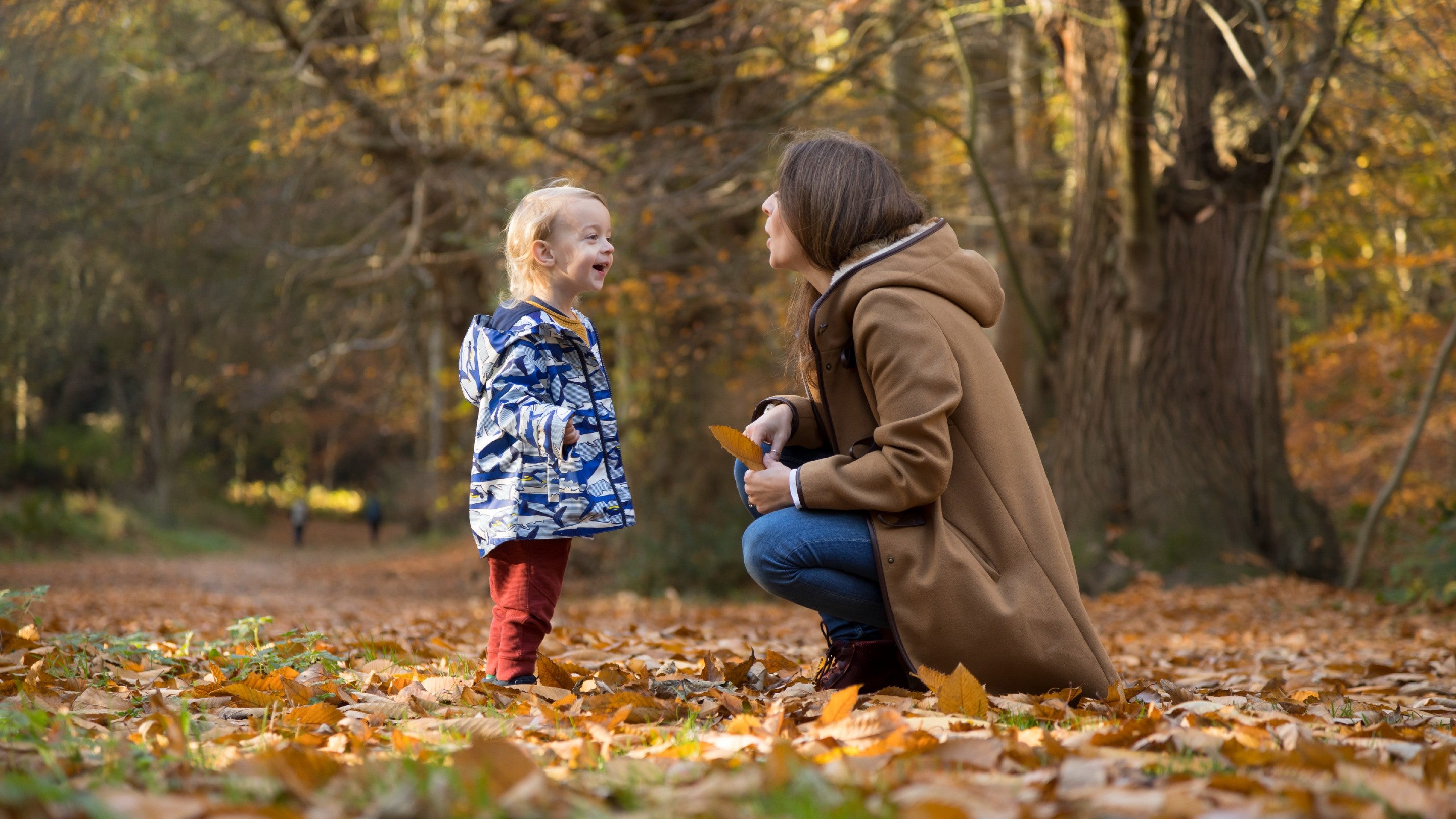 Mother and son looking at the autumn leaves