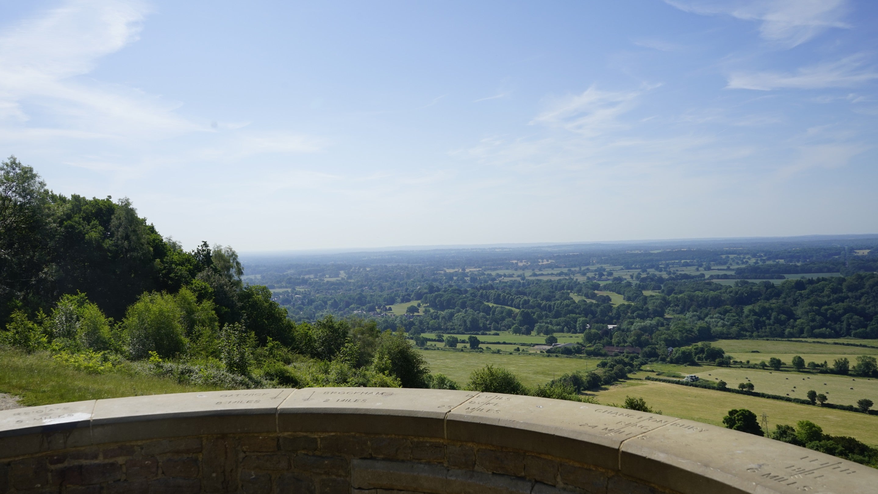The view from Salomons' Memorial across green fields and Dorking town towards Leith Hill