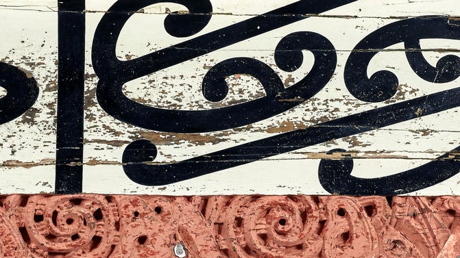 A Māori whakairo (carving) painted red with white and black painted patterns from the wharenui (meeting house) Hinemihi