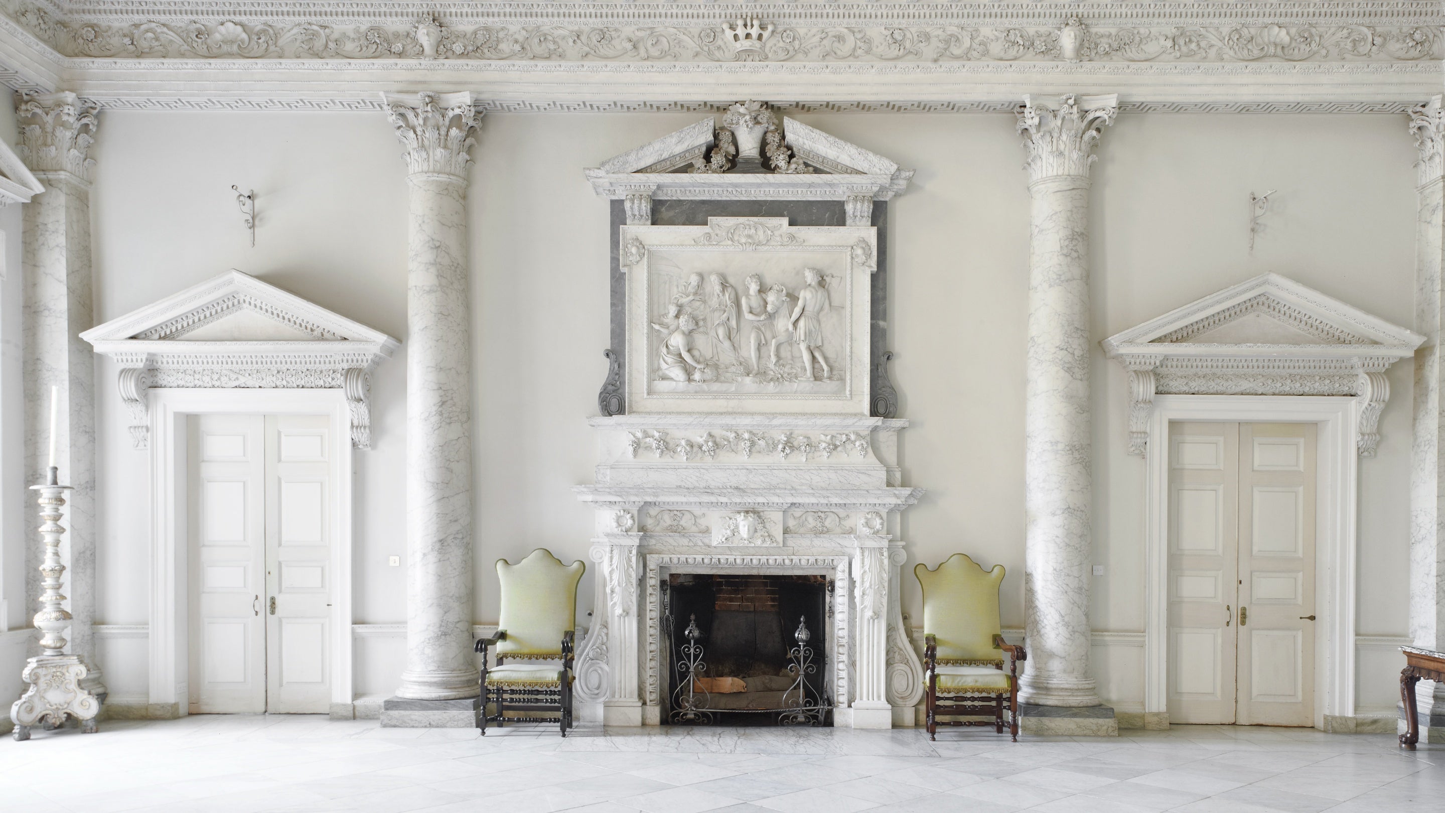 A view of the fireplace and surrounding wall detail inside the Marble Hall at Clandon Park, Surrey before the fire in 2015