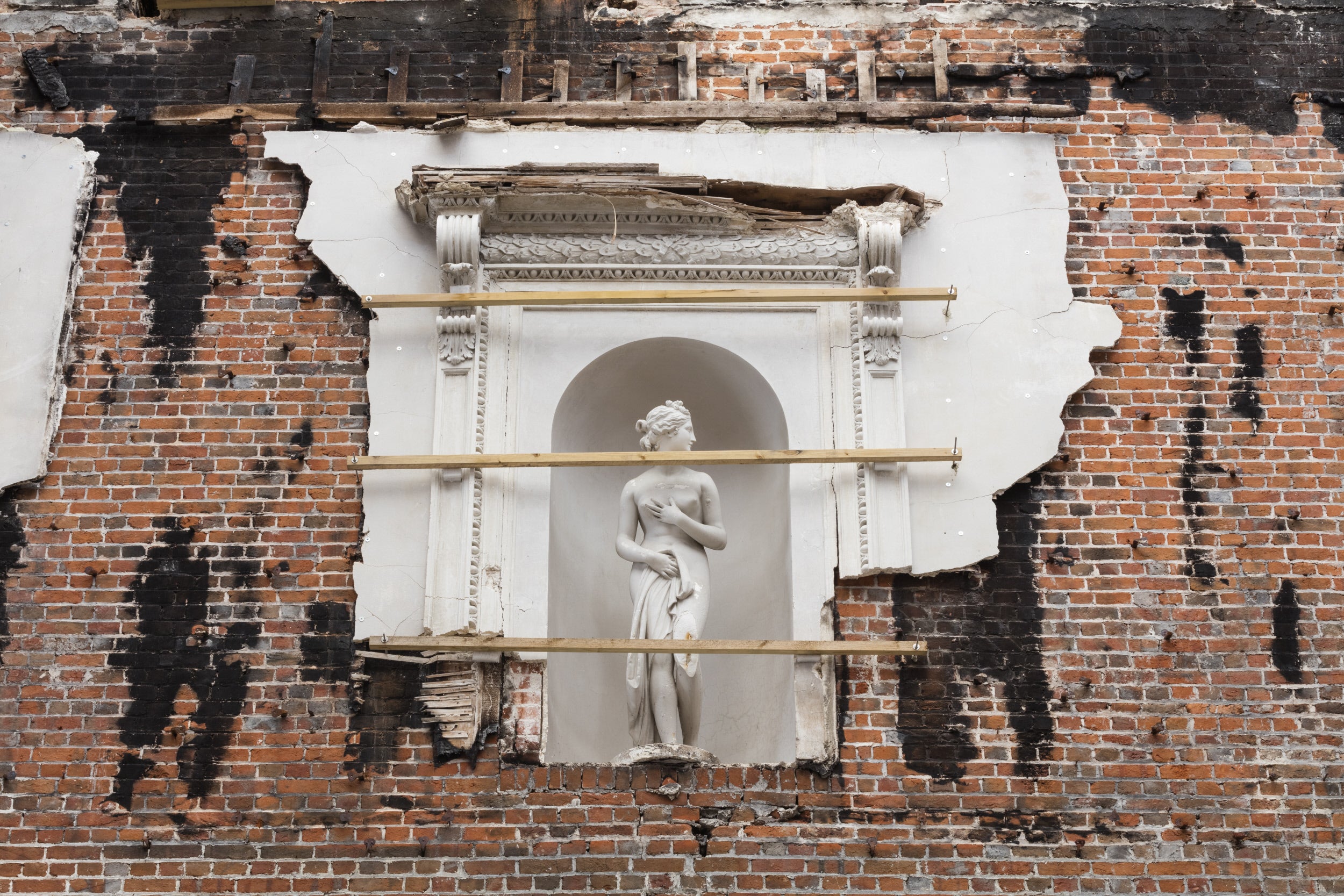 Statue fixed to the brick wall at Clandon Park Surrey