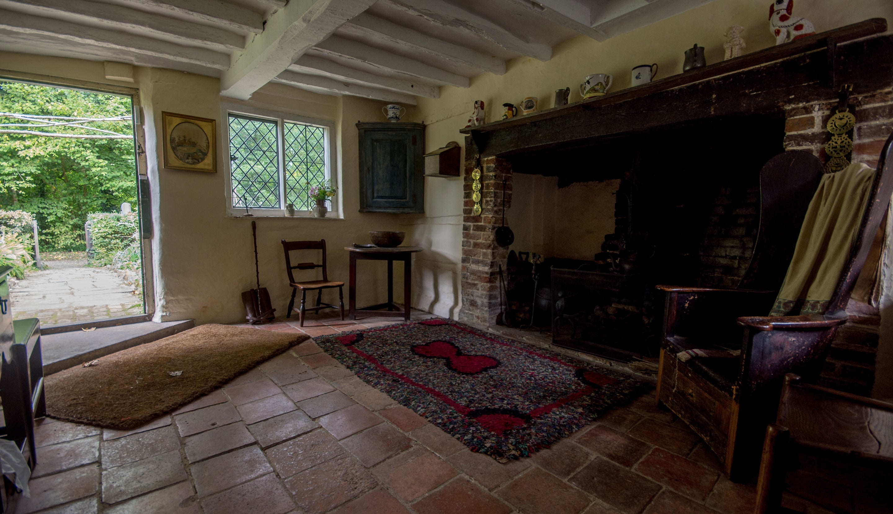 The living room at Oakhurst cottage featuring the hearth and suspended iron pot.