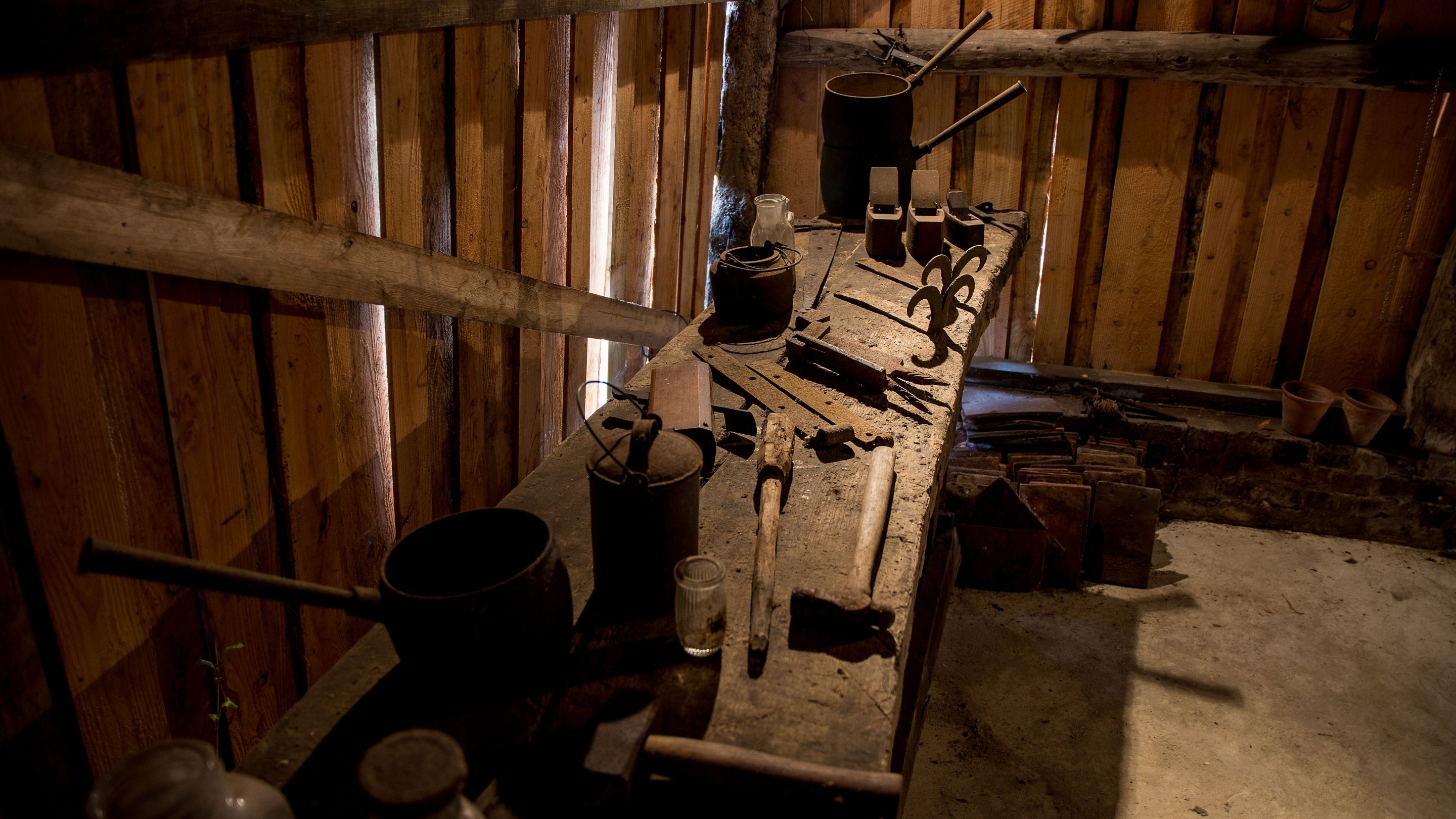 The interior if the barn at Oakshurst cottage with gardening tools and other implements