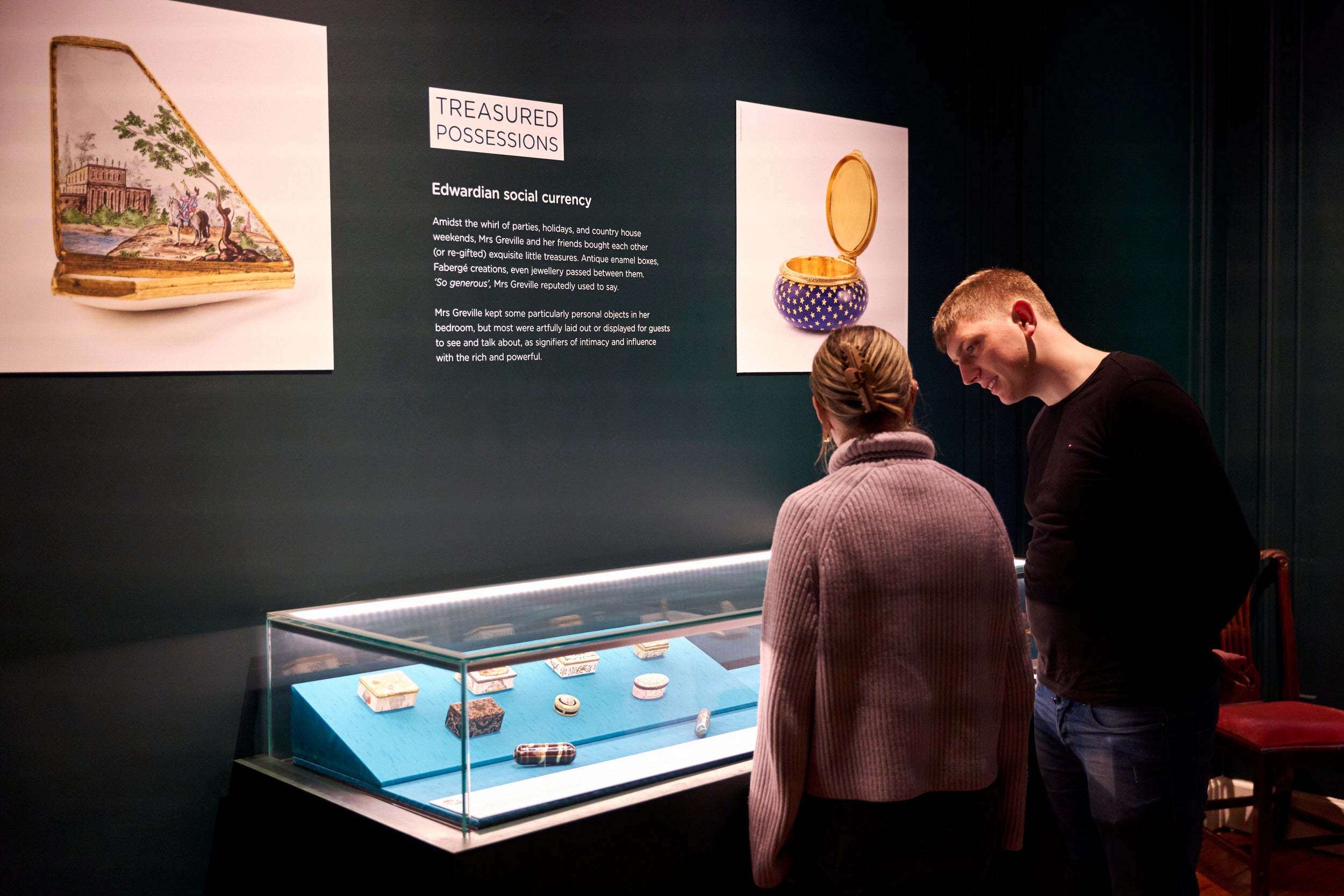 Visitors looking at the Treasured Possessions Exhibition at Polesden Lacey