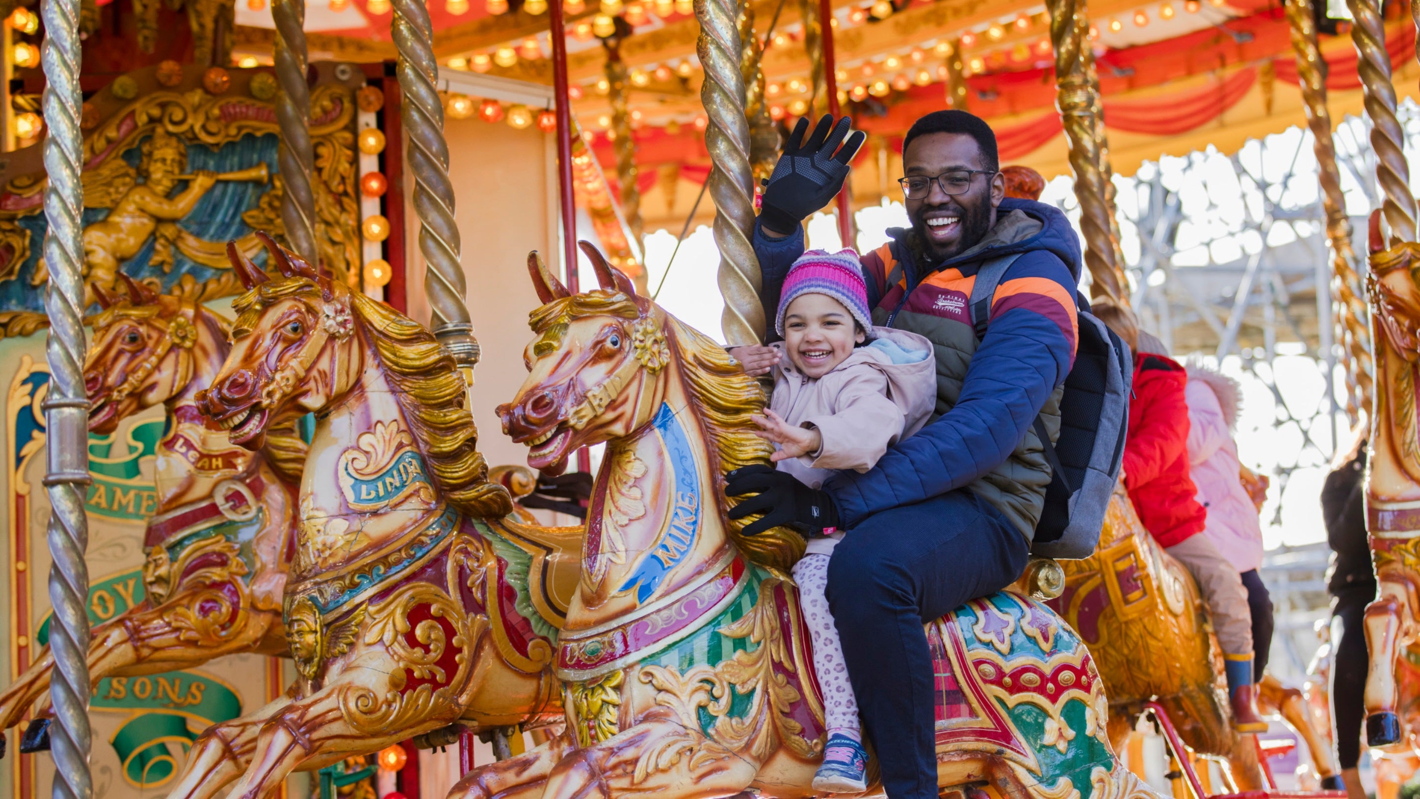 Visitors enjoying a carousel ride during Christmas at Polesden Lacey, Surrey