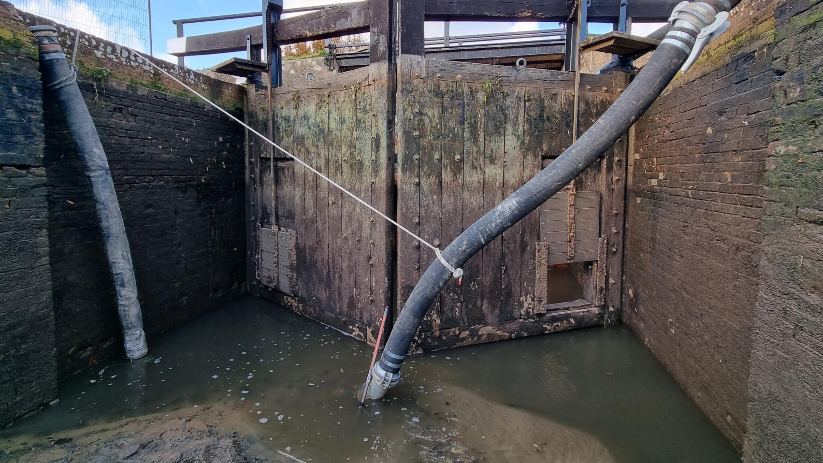 Old upper lock gates in place in front of the dam at St Catherine's, River Wey, Surrey