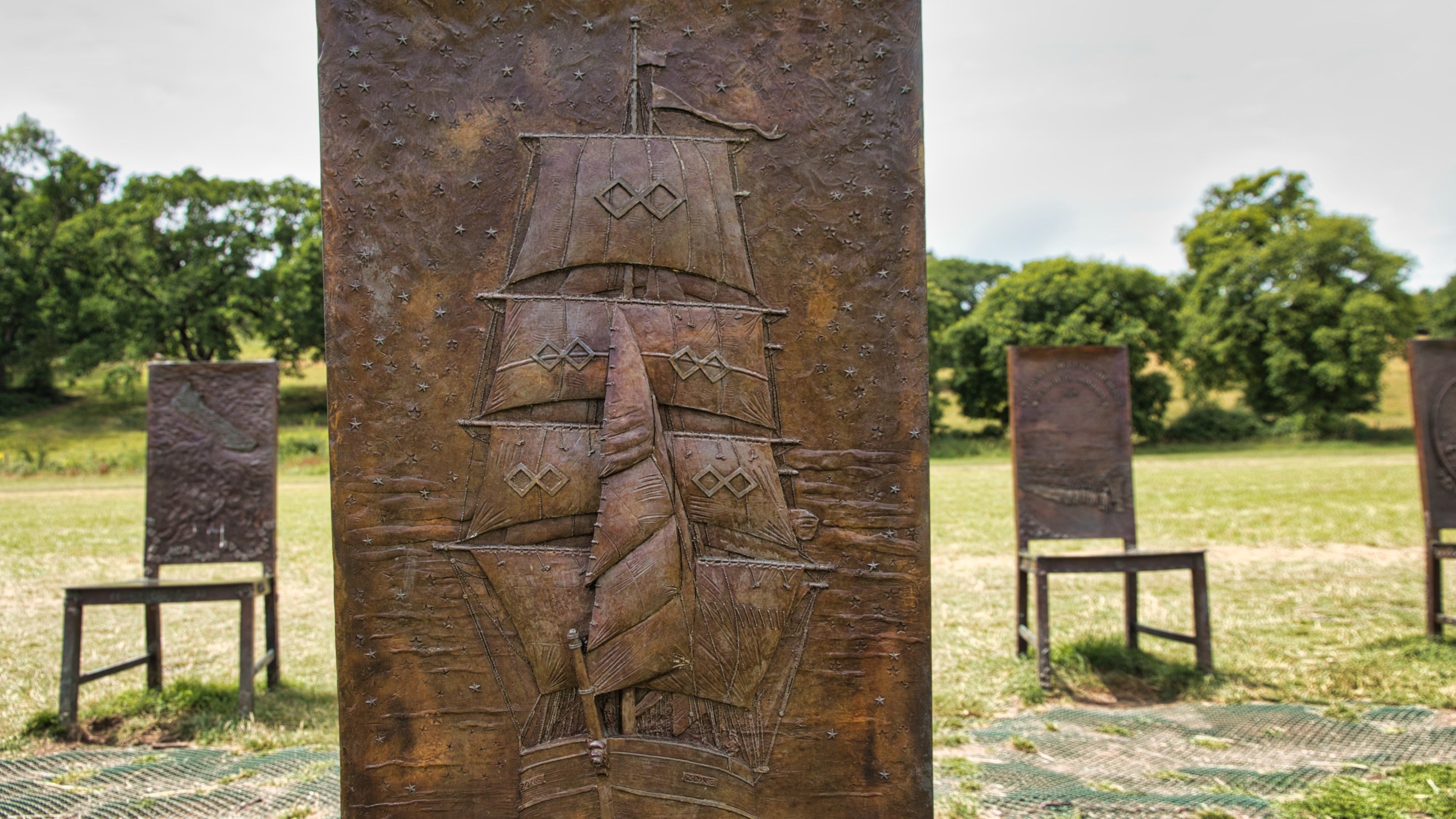 Close-up of chair 11 of The Jurors by Hew Locke, an artwork on display at Runnymede, Surrey, showing the slave ship Zong 