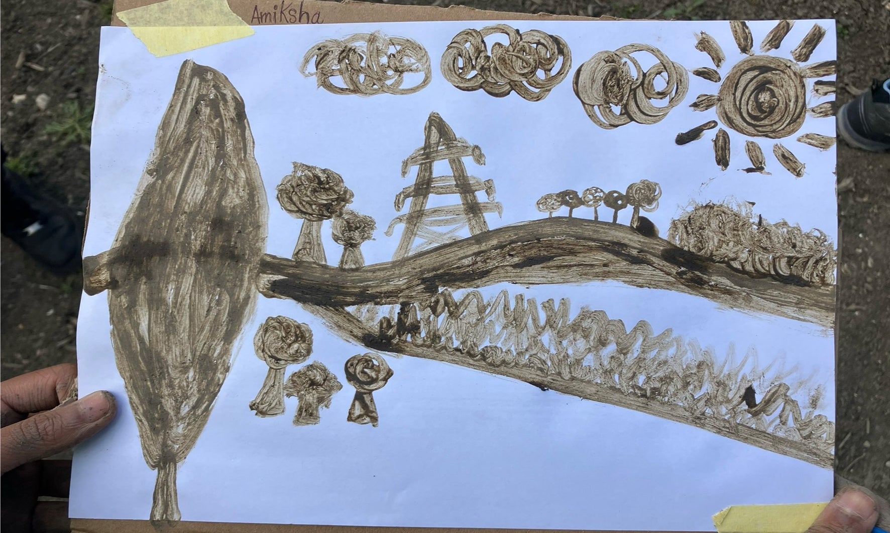 A finger painting  of the local landscape that has been painted using soil