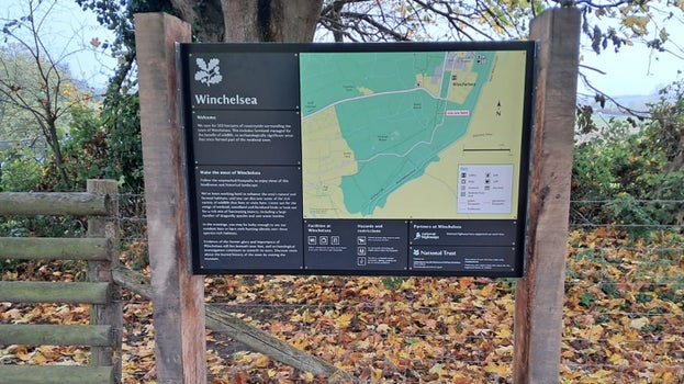 Sign board in front of a tree