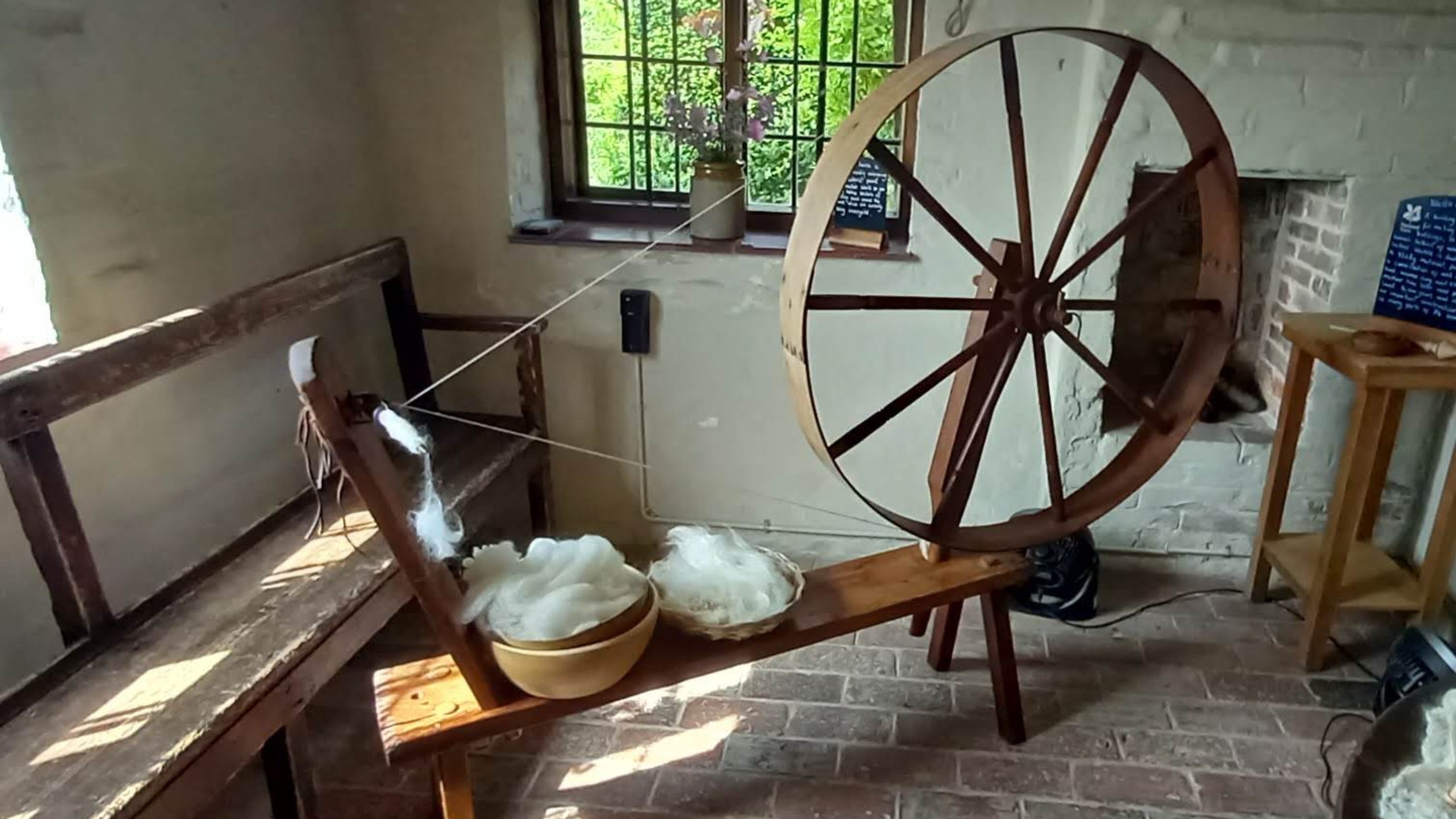 View of the Lower Parlour with spinning wheel, Alfriston Clergy House, East Sussex
