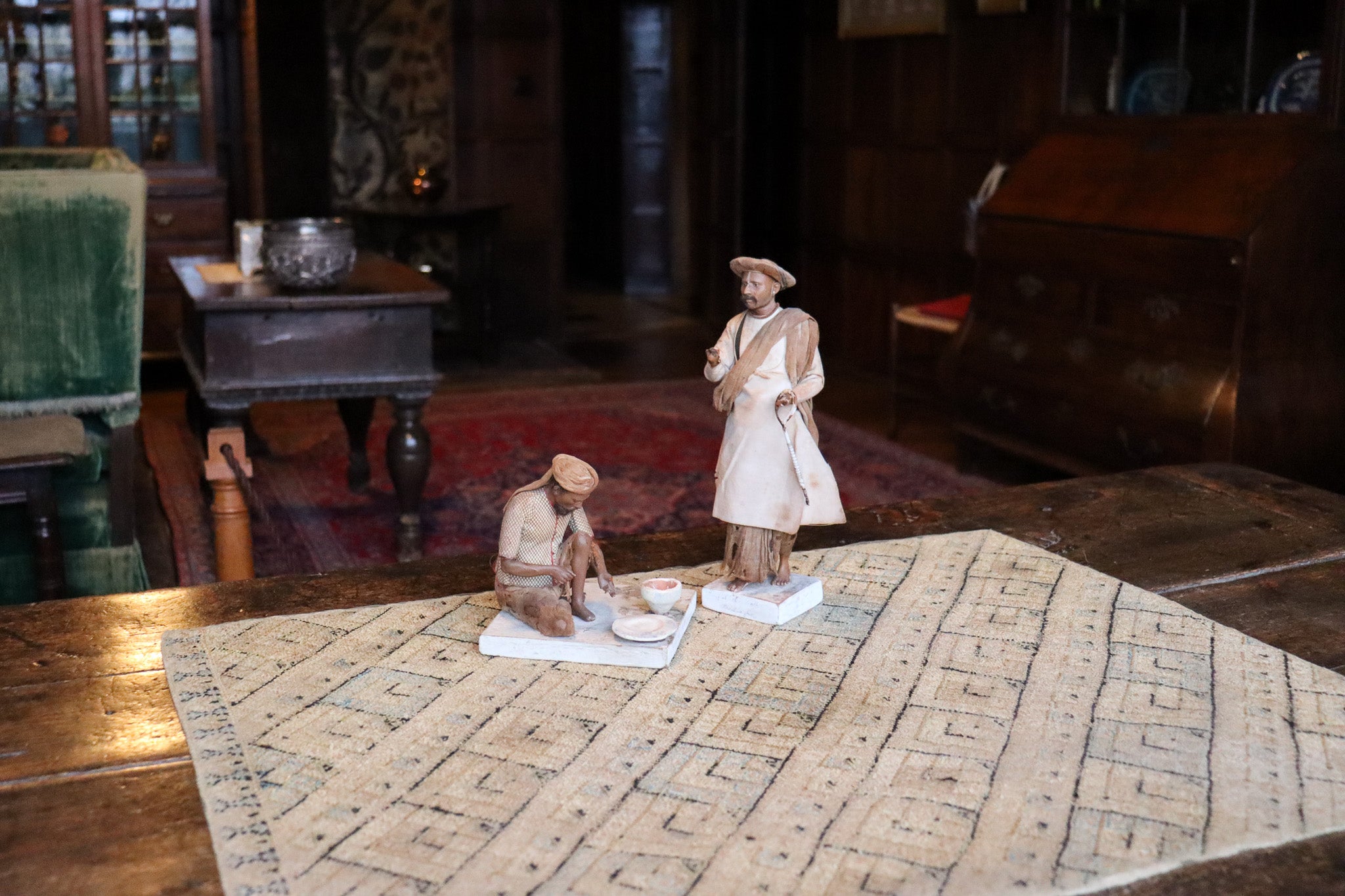 Two clay figures depicting Indian labourers