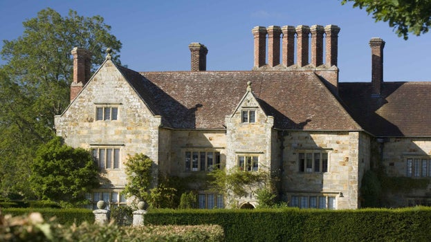 The stone frontage and six chimneys of Bateman's, East Sussex