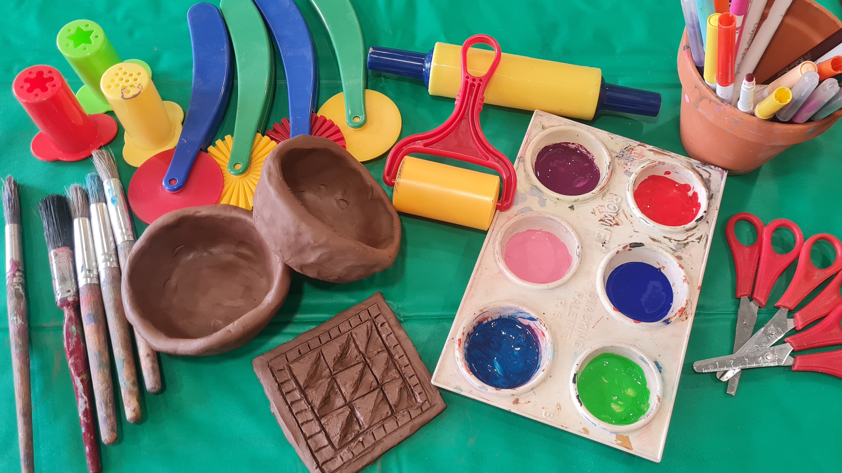 Clay model of a pot and tile with paint and craft materials