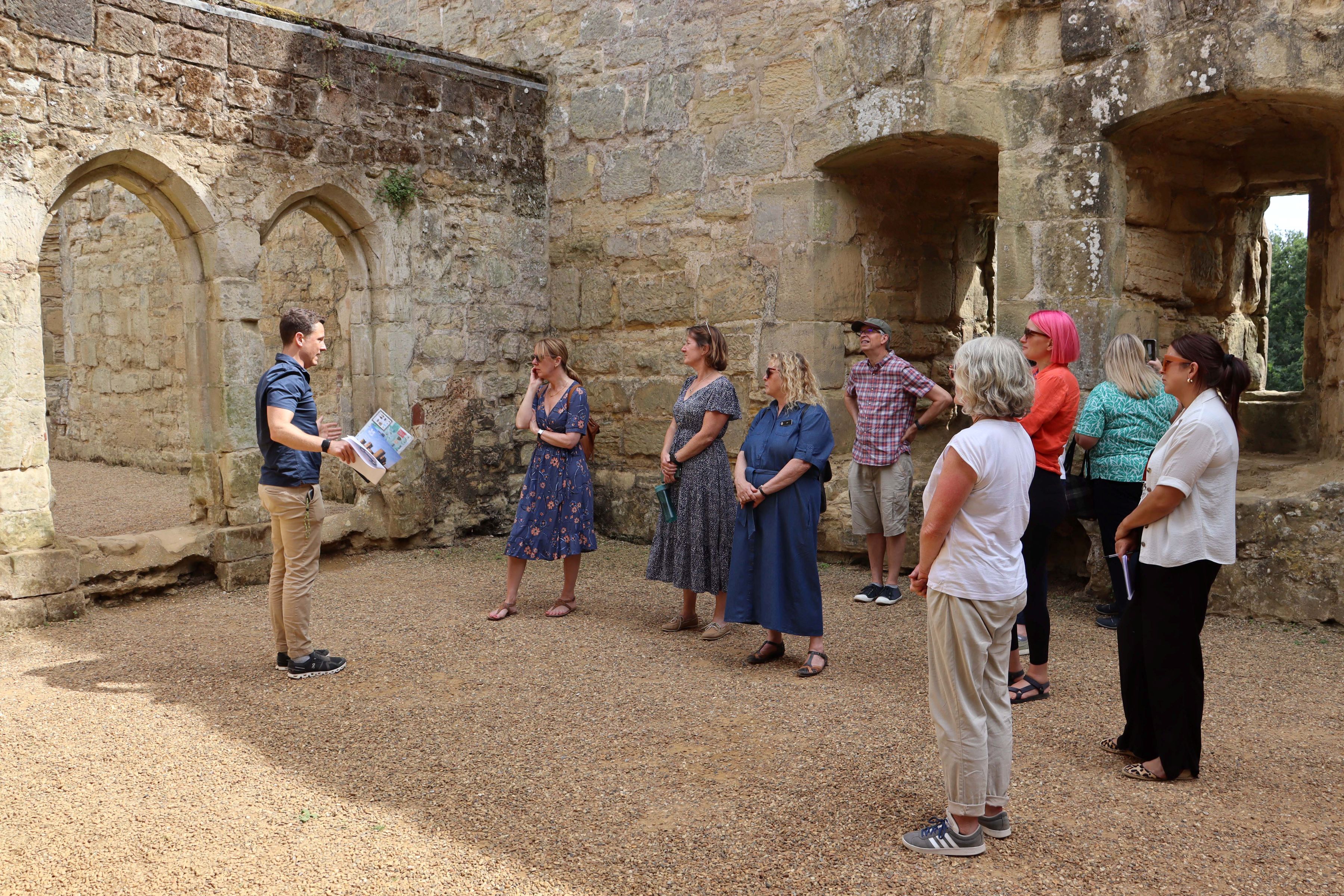A group of people standing inside the castle