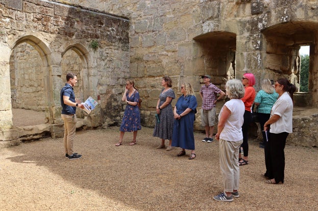 A group of people standing inside the castle