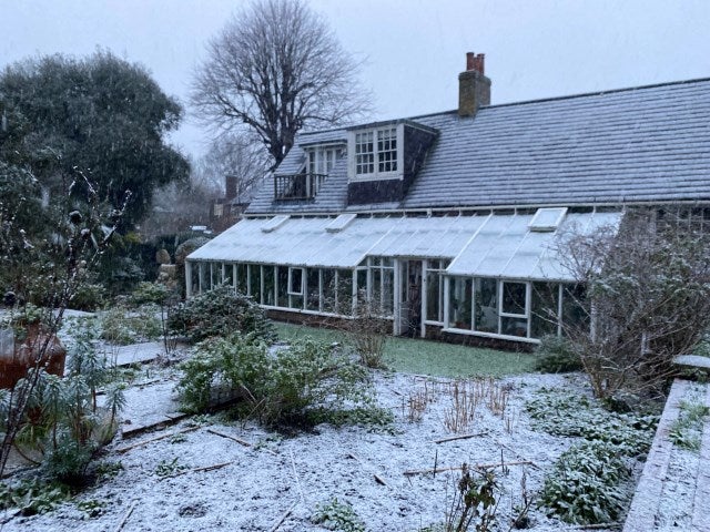 Monk's House, conservatory side and front beds with a light dusting of snow, winter 2025.