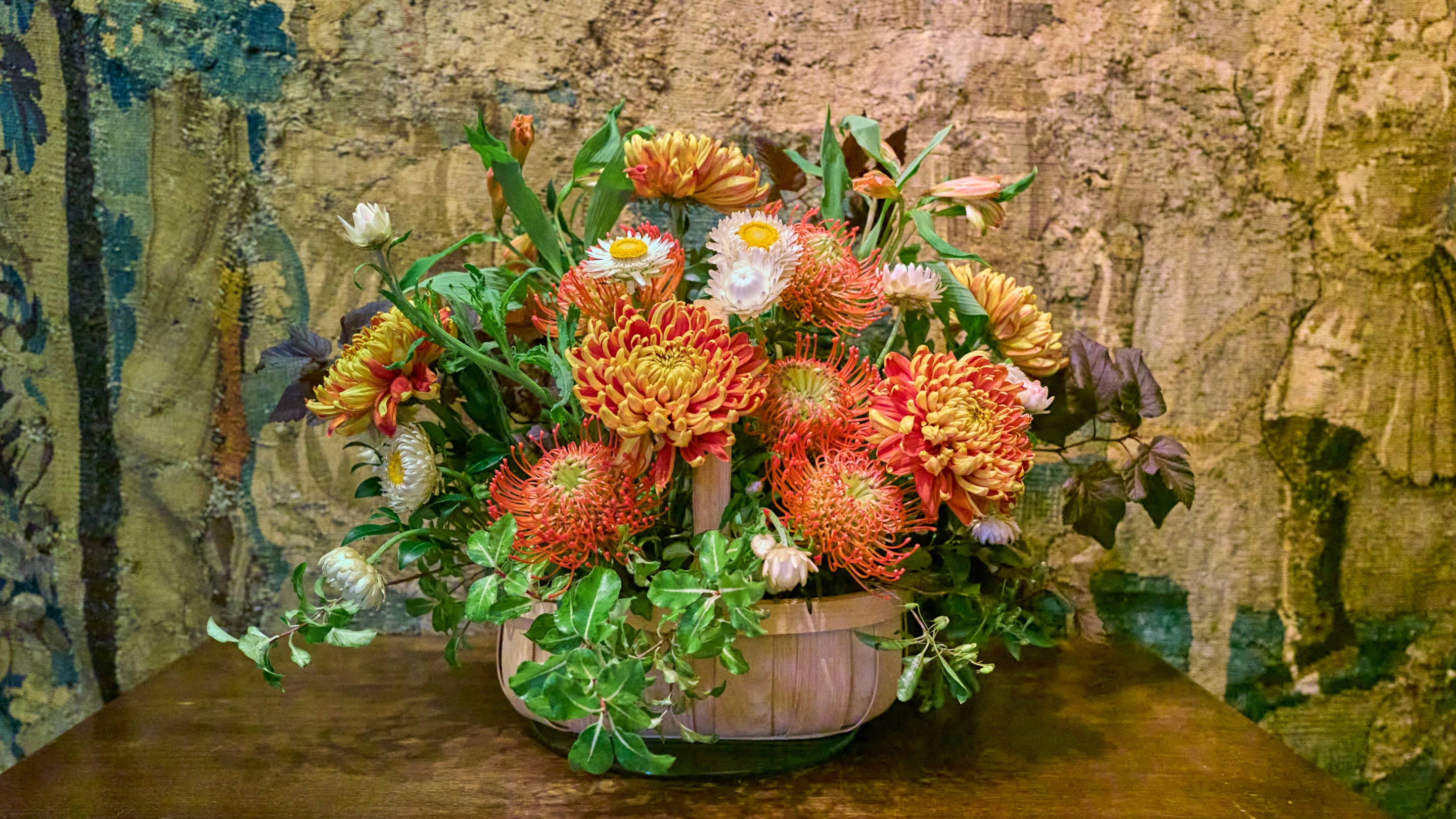 An arrangement of flowers in autumnal orange
