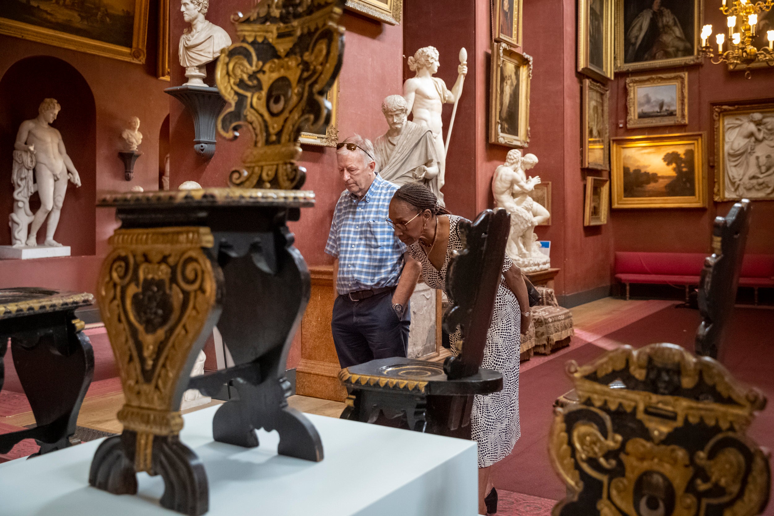 Visitors exploring the 125 Treasures exhibition at Petworth House and Park, West Sussex