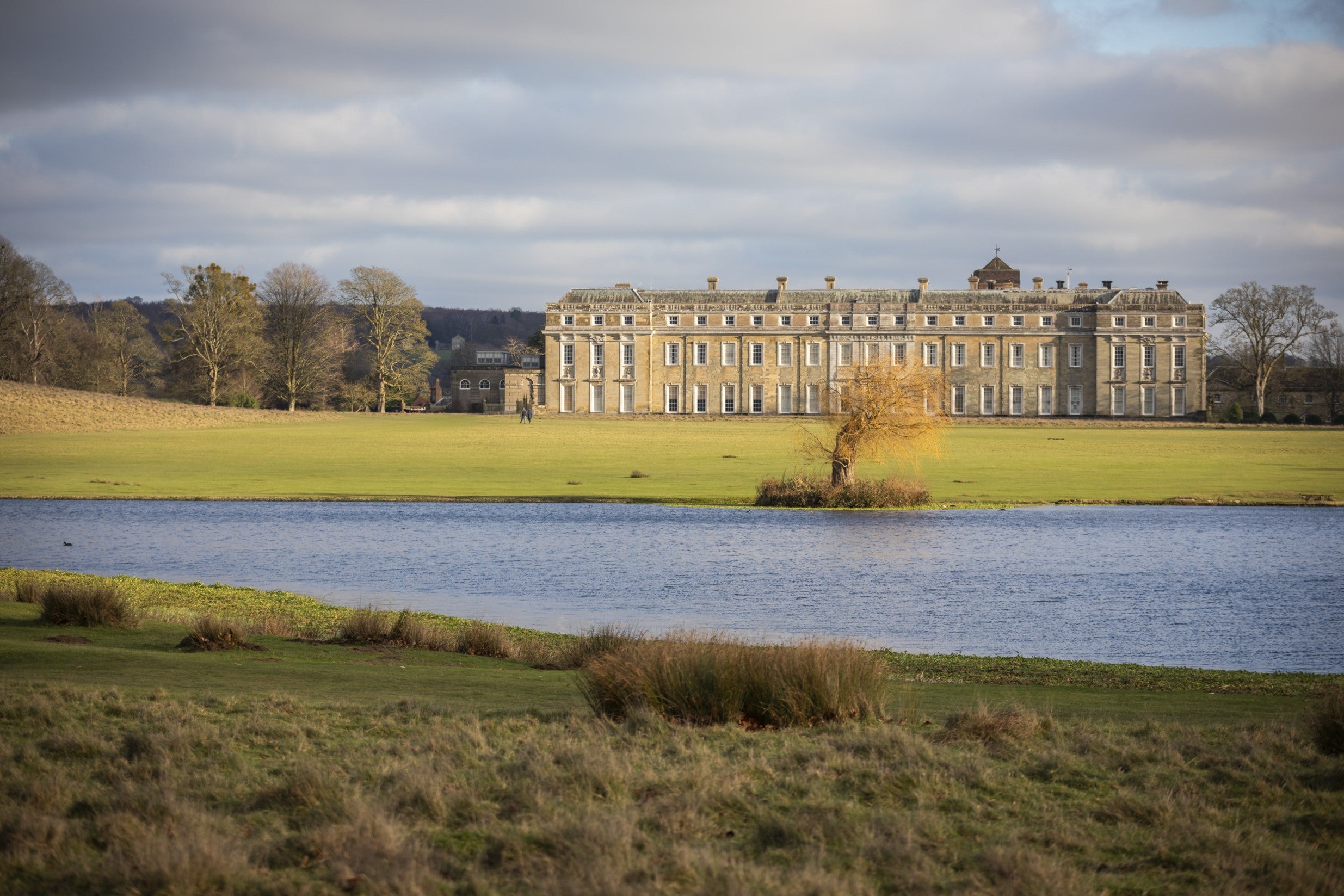 View across Upper Pond towards the mansion at Petworth House and Garden, West Sussex