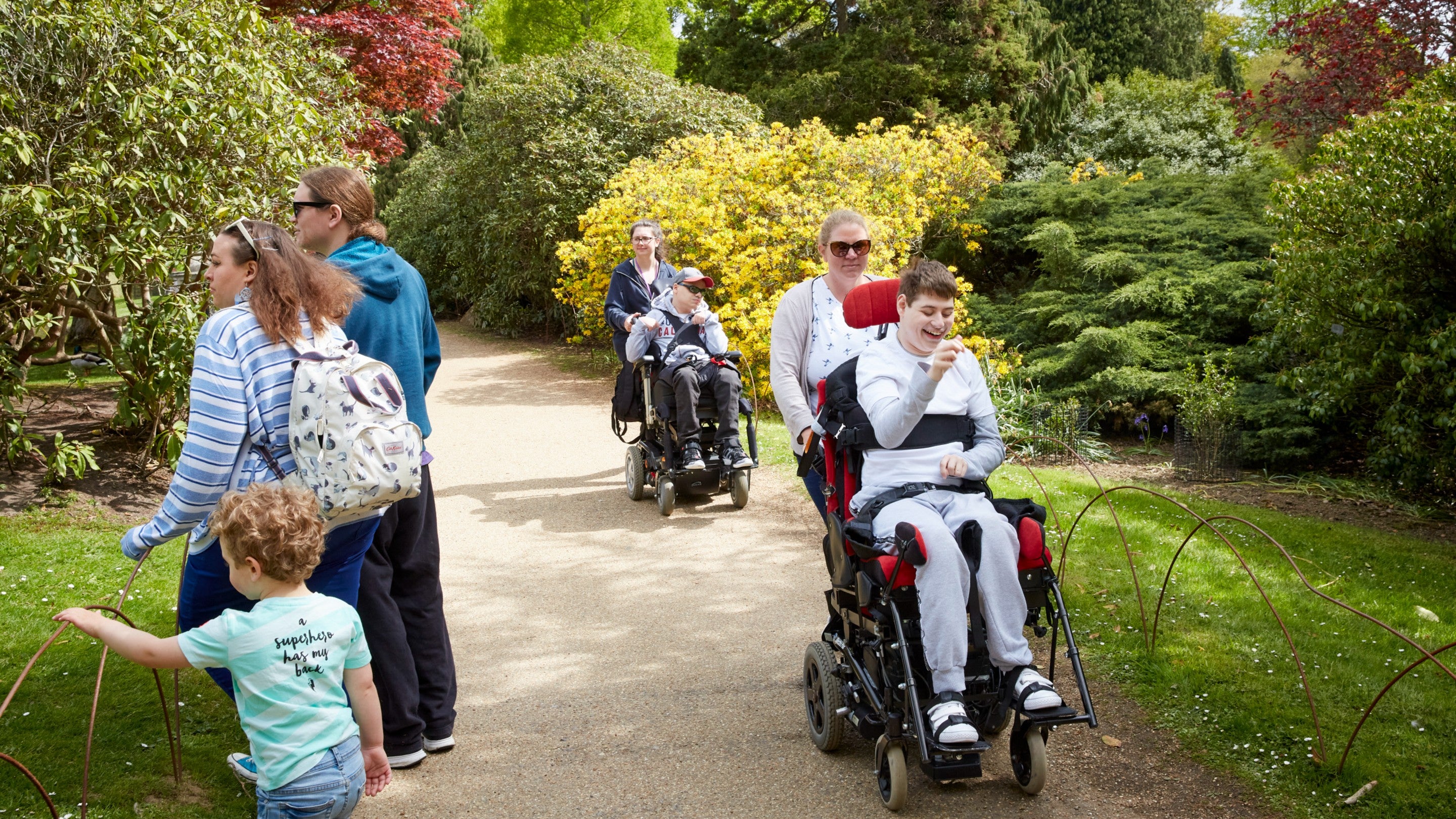 Visitors using a wheelchair in the gardens at Sheffield Park and Garden, East Sussex