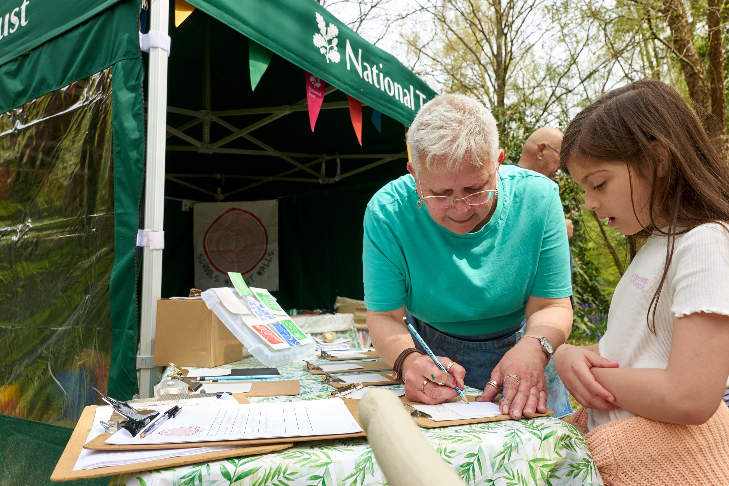 A child trying out some nature crafts at an outdoor workshop event