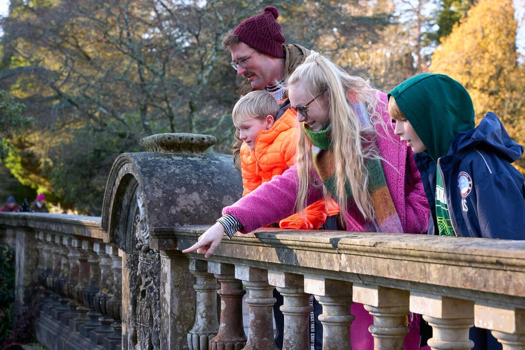 A family standing on a bridge at Sheffield Park and Garden