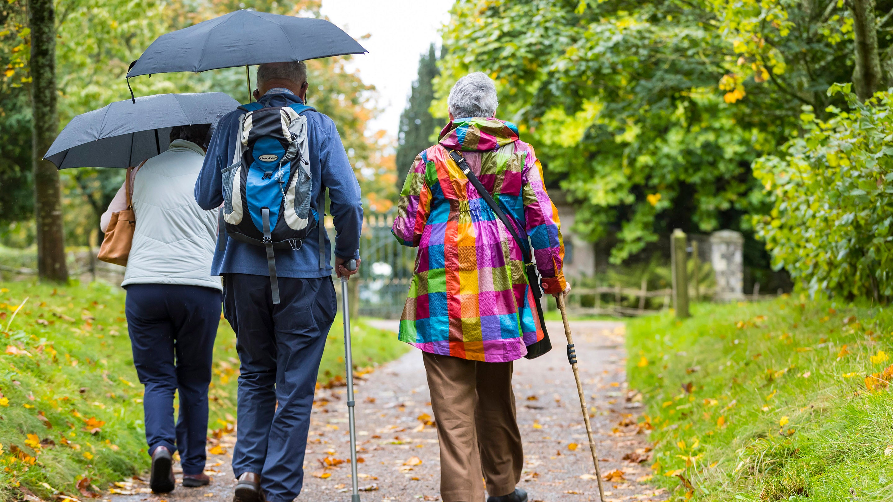Visitors in the garden on a rainy day at Uppark House and Garden, West Sussex