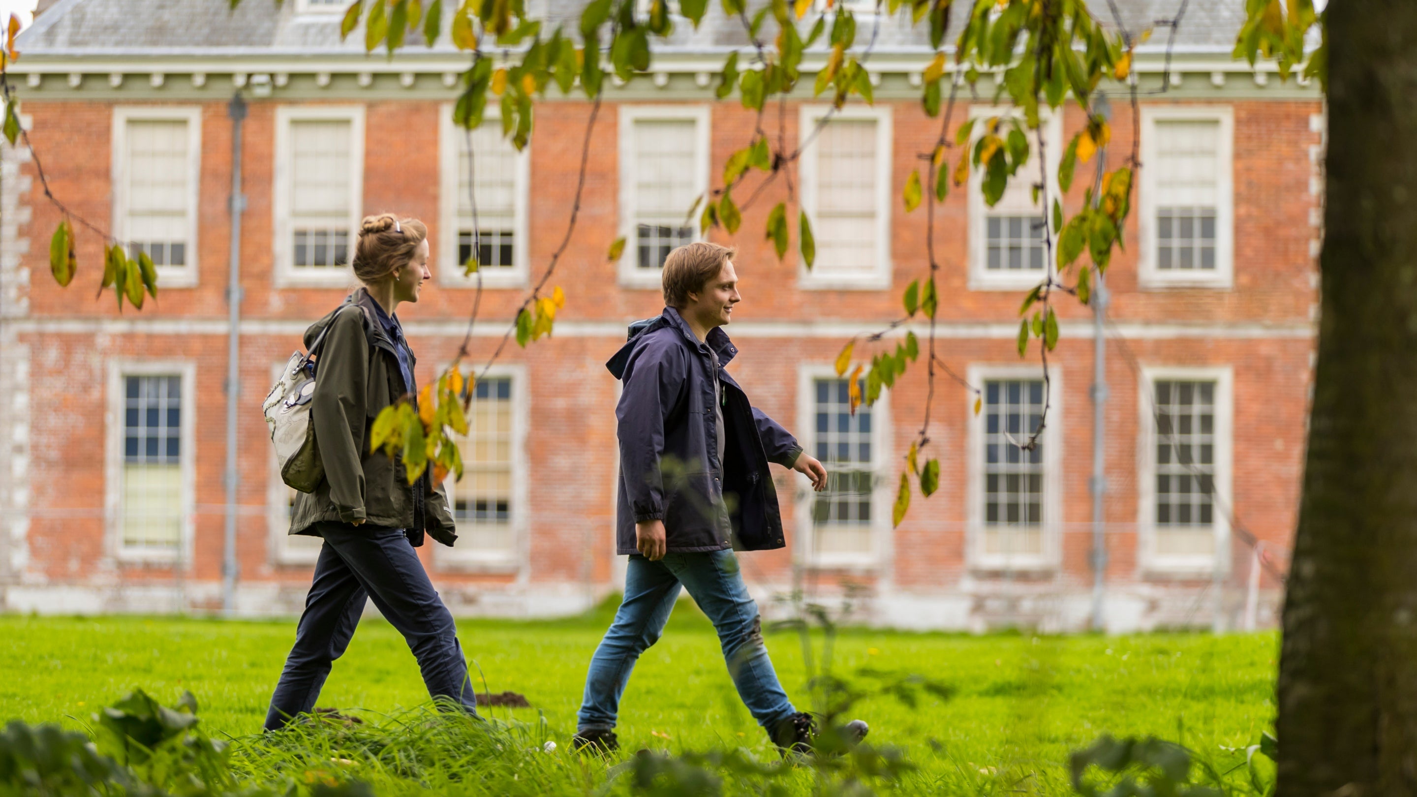 Visitors in the garden in autumn at Uppark House and Garden, West Sussex