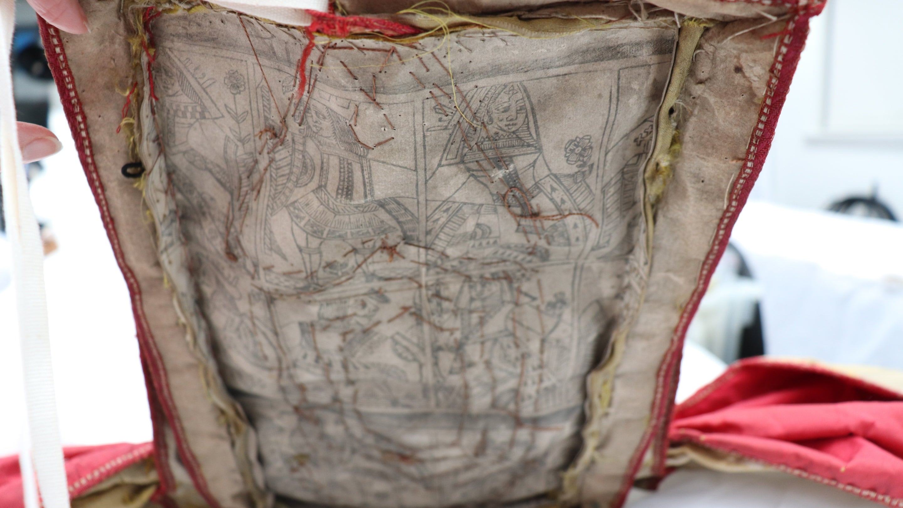 A piece of fabric with outlines of playing card images, at Uppark, West Sussex