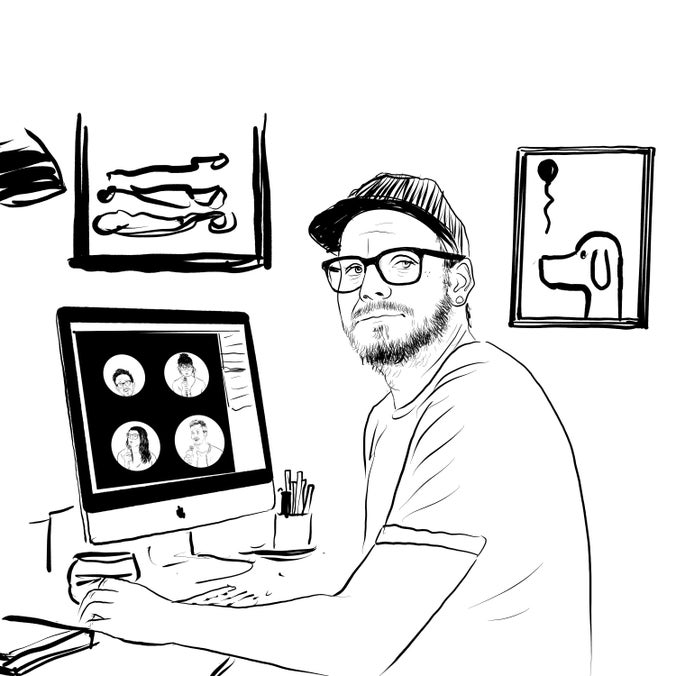 A drawing of Bedwyr sat by his desk with some digital drawings on the computer