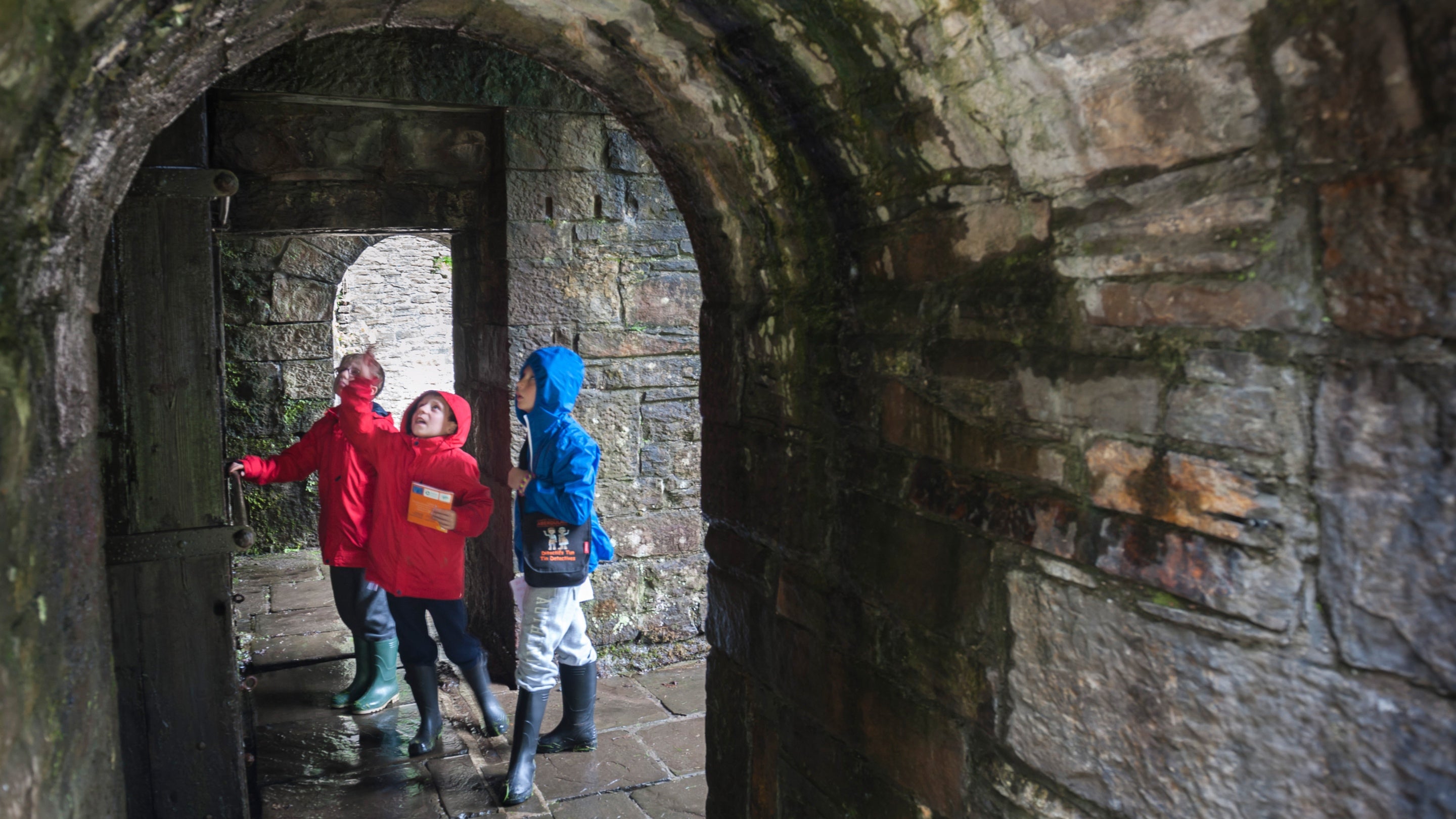 Children under the bastion at Aberdulais Tin Works, South Wales