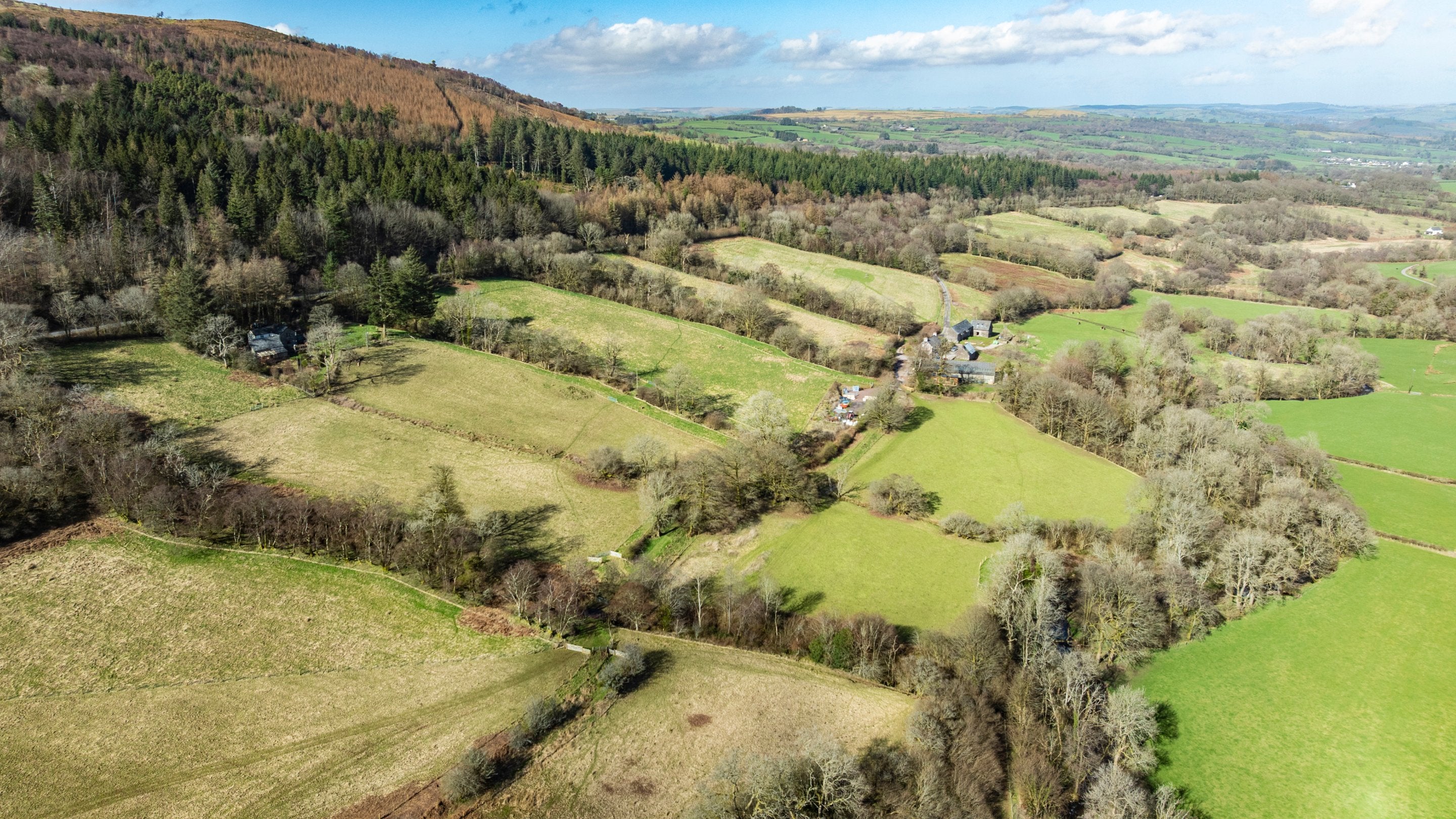 An aerial view of a valley of fields, hedgerows and woodlands at Ty Mawr Farm, Bannau Brycheiniog (Brecon Beacons)