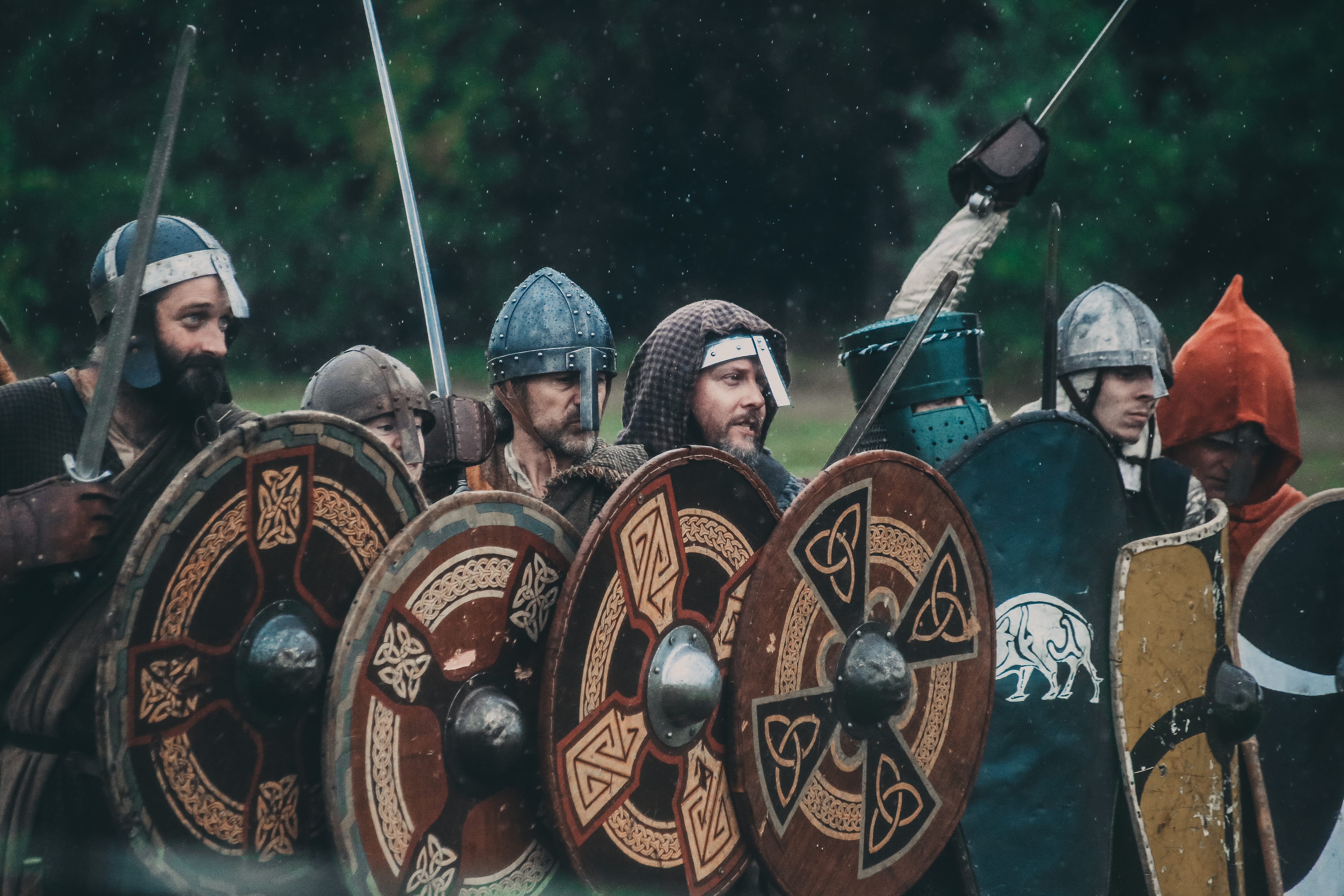 Historical re-enactors carrying decorated shields and weapons during a Battle of Crogen re-enactment.
