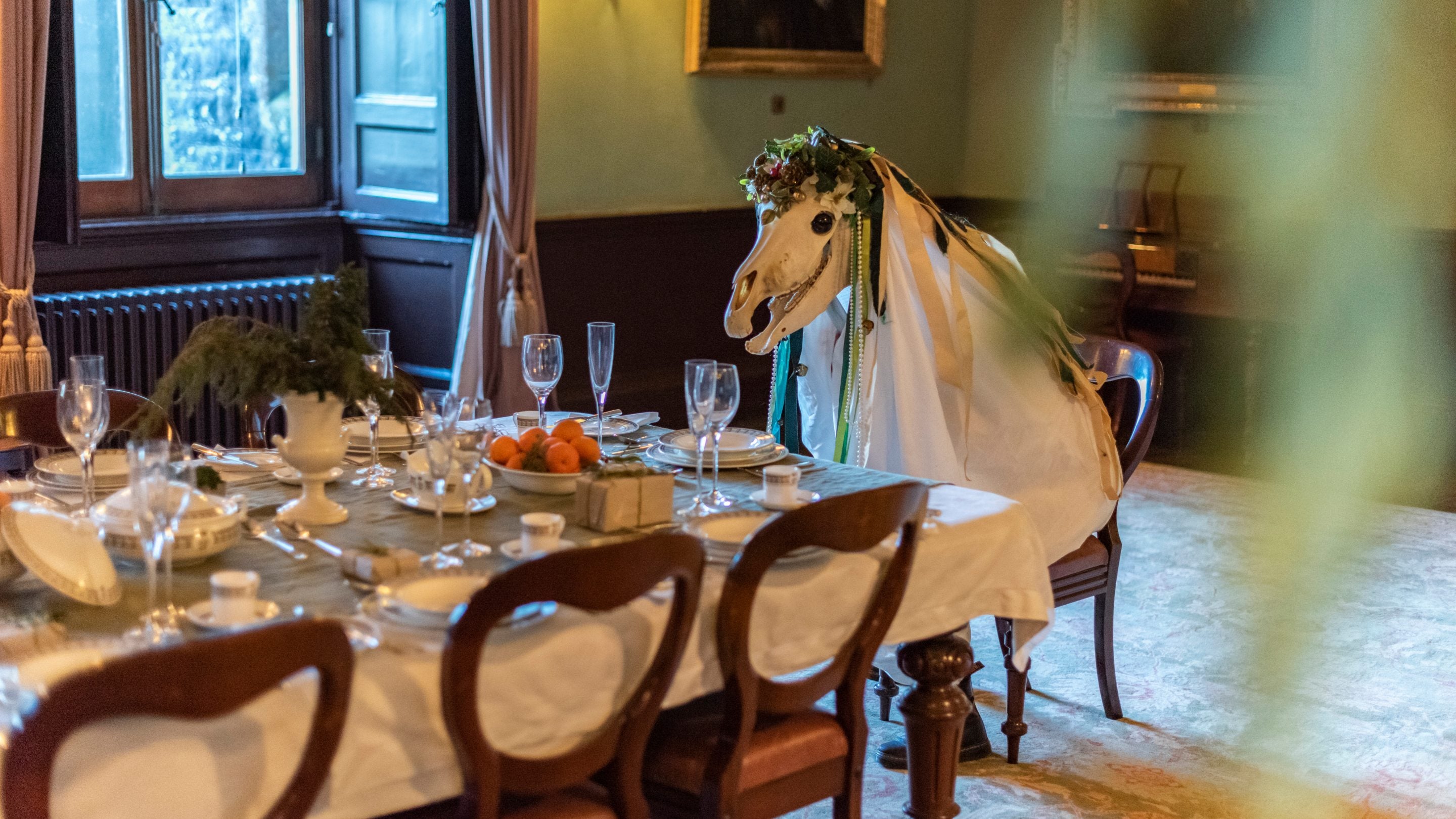 The traditional Mari Lwyd - a horse's skull surrounded by a decorated draping white sheet - visiting Newton House at Dinefwr, Carmarthenshire