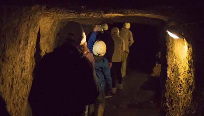 Visitors underground in the Roman mine