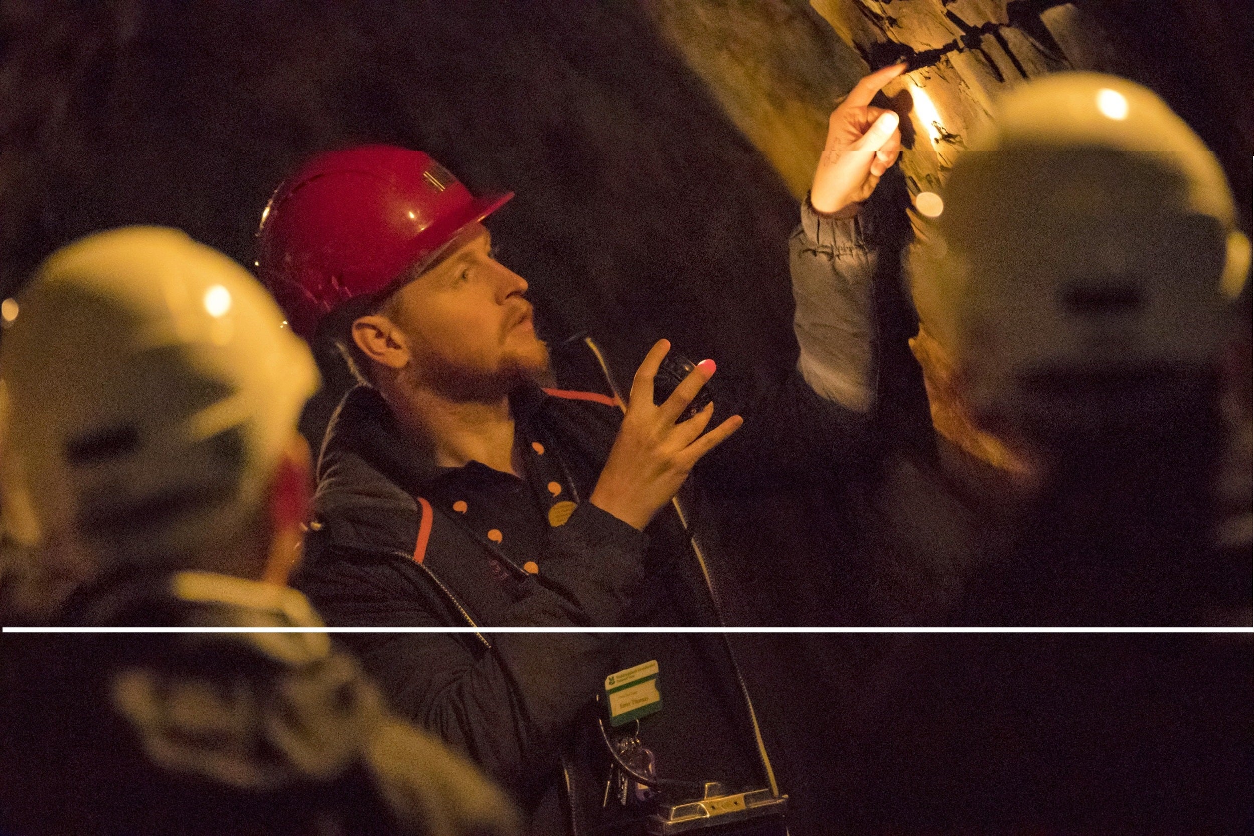 Tour guide with visitors at Dolaucothi Gold Mines, Carmarthenshire