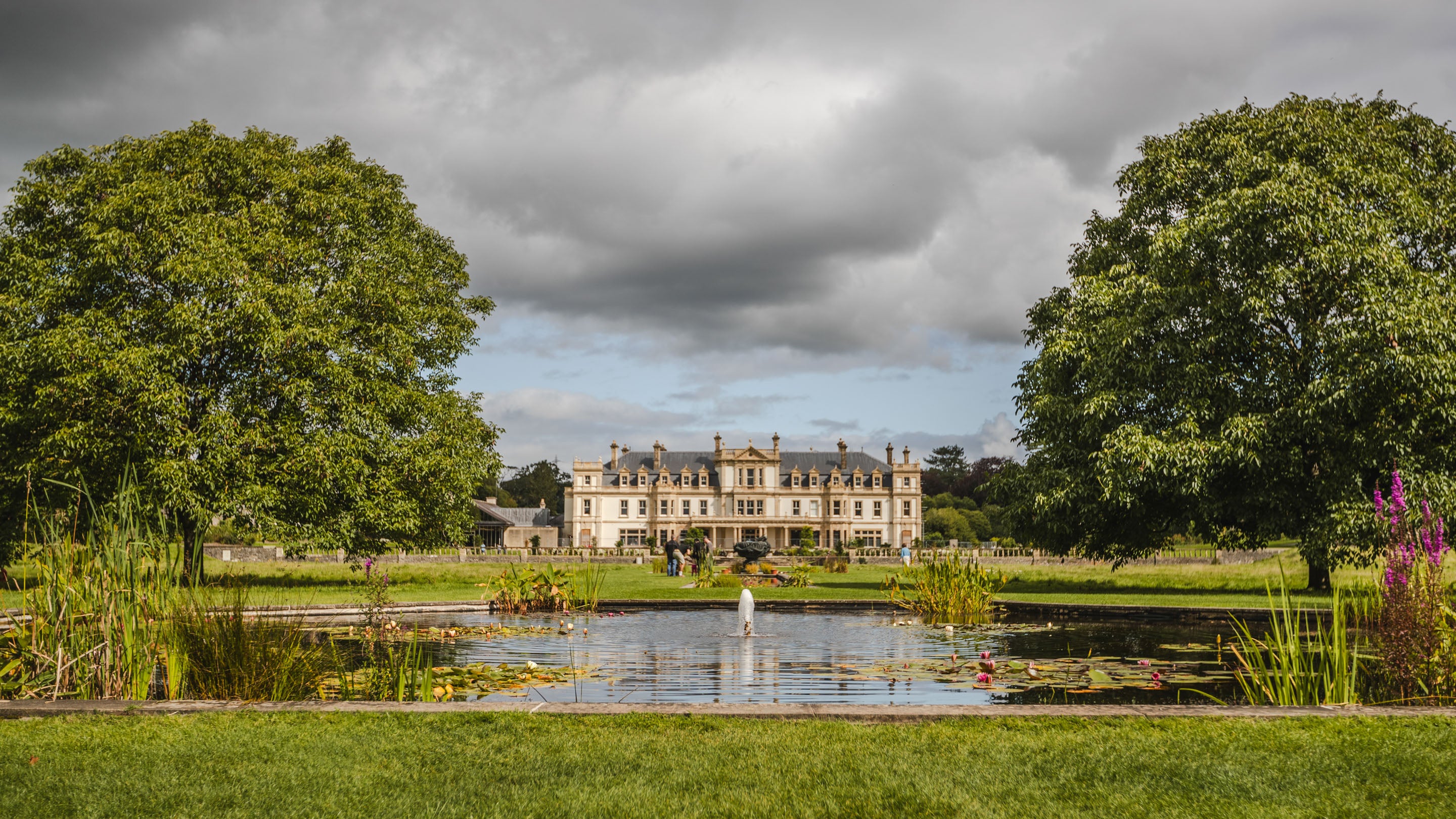 View of the restored exterior of the house from the Fountain Pool at Dyffryn Gardens