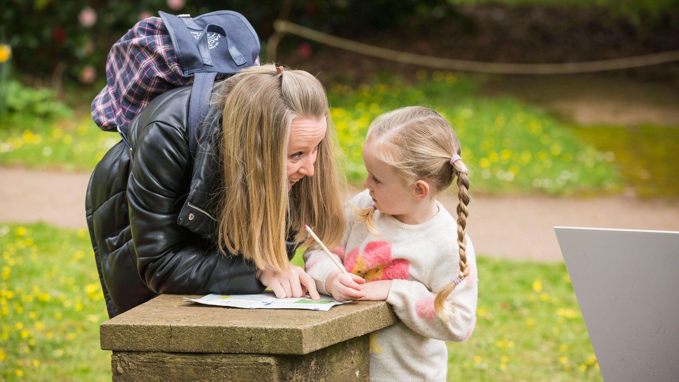 Mother and daughter filling out the Easter trail sheet together at Dyffryn Gardens, Vale of Glamorgan