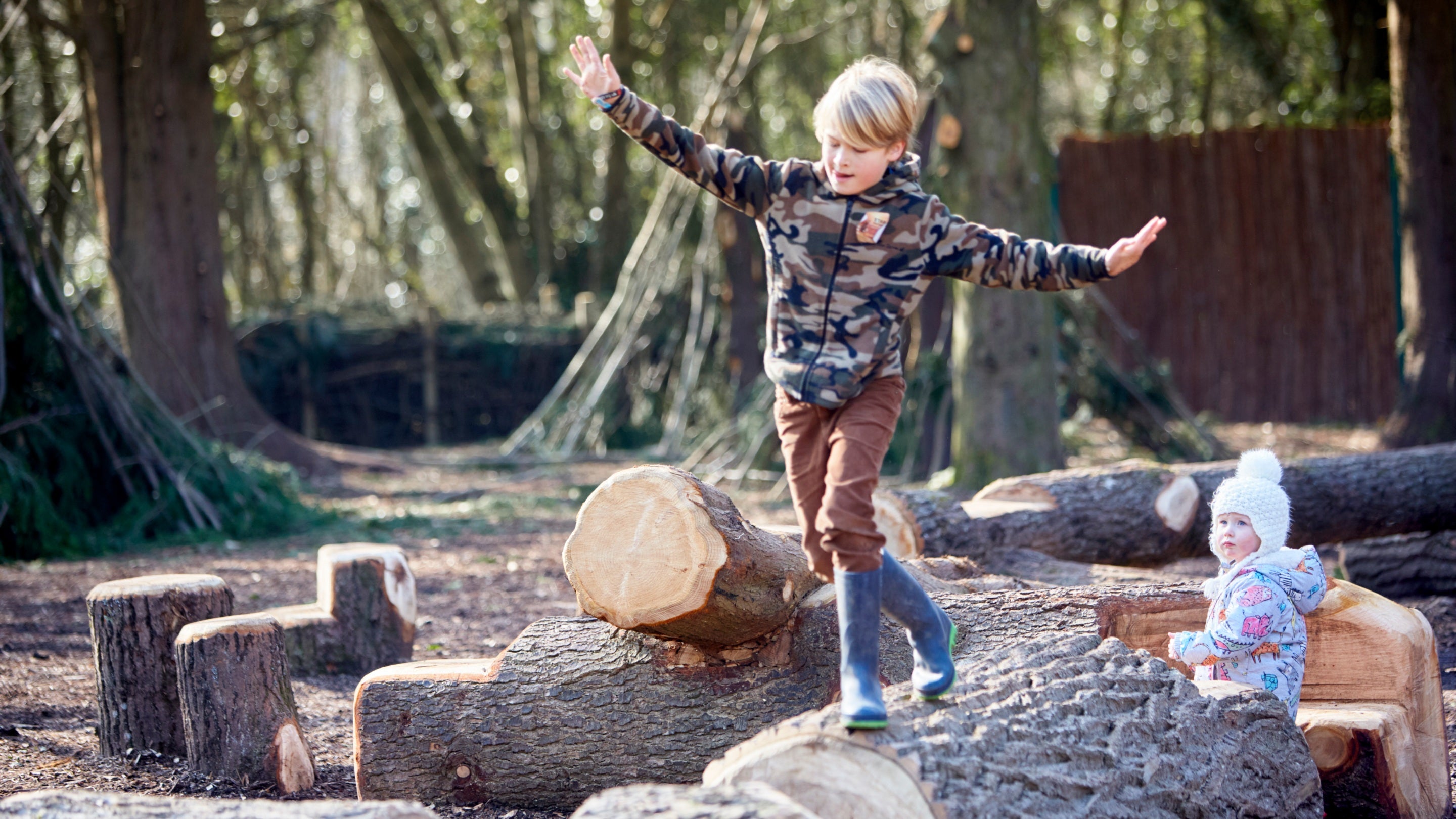 Children exploring the wild play area at Dyffryn Gardens, Cardiff, Wales.
