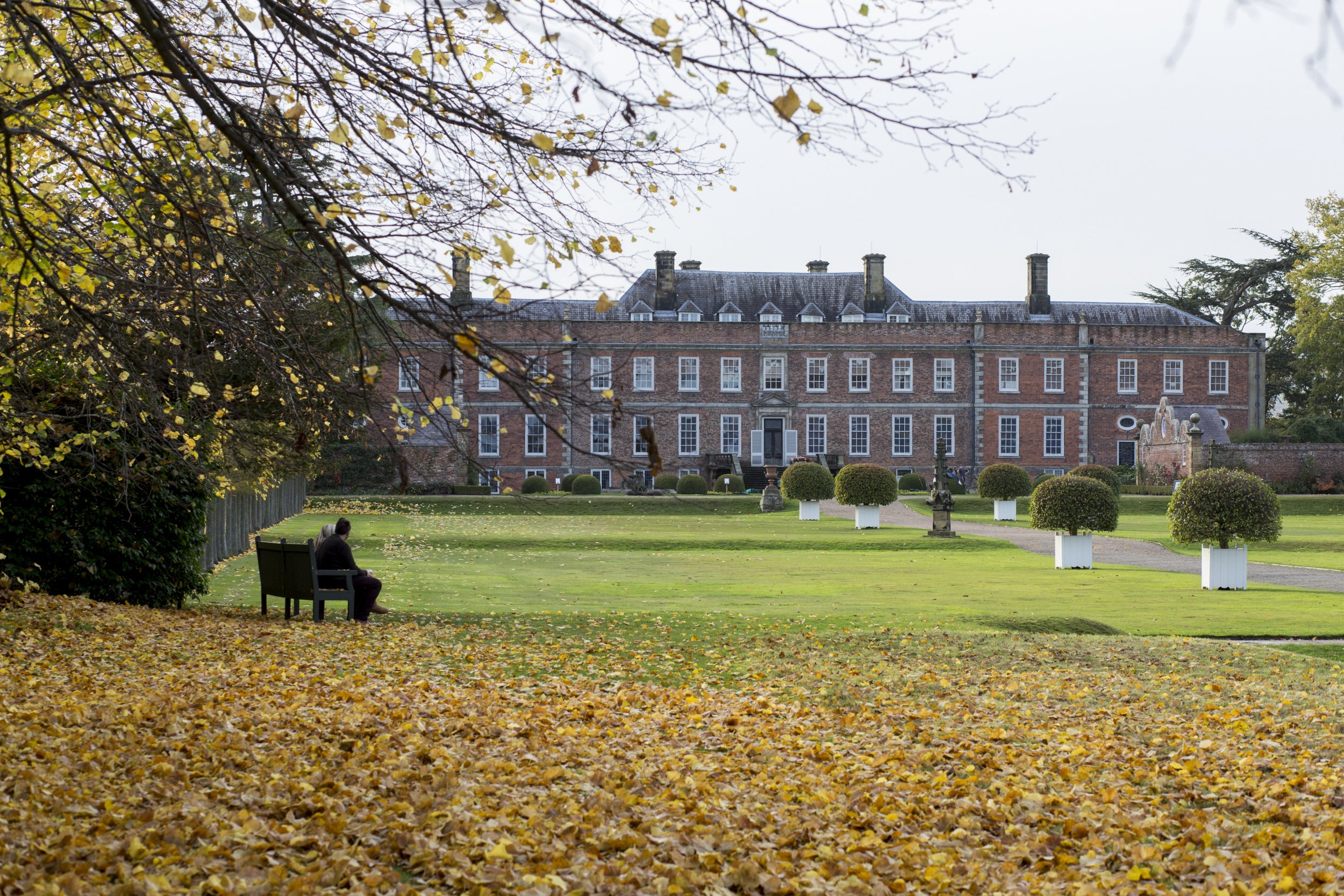 A visitor enjoying the autumn views of Erddig Hall